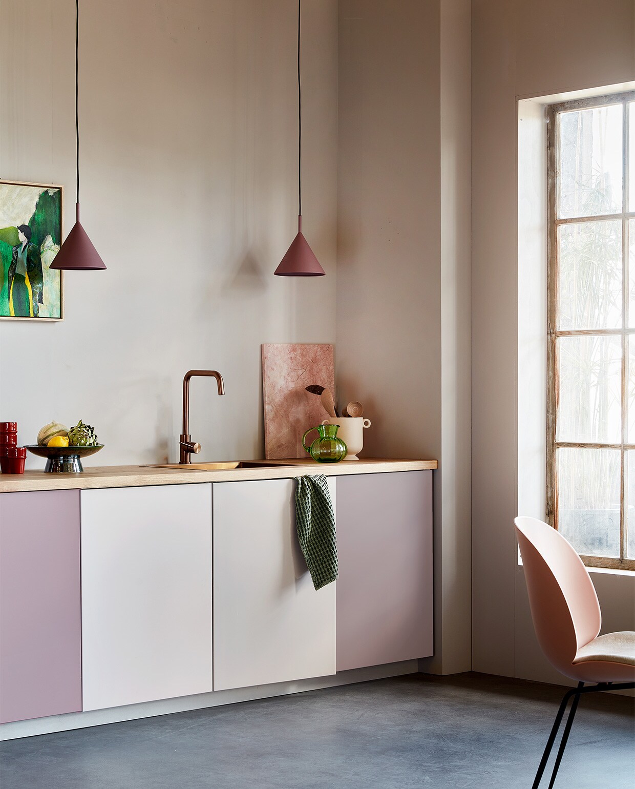 Muurverf Flexa Easycare Keuken kleur Cosmic Glory, per liter € 25,49, verf kastdeuren Flexa Mooi Makkelijk Keukenkasten kleur Cosmic Glory, Pink Nudity en HeartWood, per 750 ml € 37,49 (flexa). Keukenkasten basiselement Metod, 60x60x80 cm (bxdxh) € 38,-, deur Veddinge, 60×80 cm (bxh) € 23,-, aanrechtblad Karlby, massief hout met eiken fineer, 186×63,5×3,8 cm (lxbxh) € 139,- (ikea.com). Koperen kraan € 315,-, spoelbak € 349,- (caressi.com). Paarse hanglampen Triangle € 95,- (hkliving.com). Roze stoel van Gubi € 705,- (stockdutchdesign.com). Rode mokken € 9,95, pollepels large € 9,95 (householdhardware.com). Kunstwerk French Nature met lijst, 40×50 cm (bxh) € 239,-, groene schaal met voet, 30 cm (Ø) € 69,-, marmeren snijplank, 50×40 cm € 109,-, groene glazen karaf € 38,- (hkliving.com). Keramieken pot € 14,95 (hm.com). Linnen theedoek € 14,95 (hetlinnenhuis). vtwonen 09-2022 | styling Leonie Mooren | fotografie Peggy Janssen