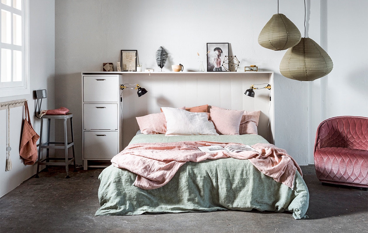 Op maat gemaakt hoofdbord inclusief kast, prijs op aanvraag (Combitex). Kleur op de wand en bedkast French Grey – Mid 162 (Little Greene). Boxspring Bekkestua € 1499,-, zwarte wandlampen Ranarp per stuk € 19,95 (Ikea). Hanglampen van groen katoen, Ø 50 cm € 89,95, Ø 65 cm € 119,95, messing ornament moleculair € 49,95 (HK Living). Fluwelen fauteuil van Patricia Urquiola, 74x75x75 cm (lxdxh) € 2130,- (Mobilia). Armband van Return to Sender € 34,95, kralenketting € 19,90, stenen hoofd klein € 34,95, hoofd groot € 12,95, zwarte lijst van Moebe € 41,95, kaars in glazen pot van Moments € 15,95, papieren doosje met slinger van Return to Sender € 17,95, houten schaal € 39,95, zwarte lijst € 21,95 met poster vrouw € 41,95, boek Move and Work € 79,90 (Loft). Zwarte veer € 7,95, standaard € 12,50, roze sprei op kruk € 24,95, roze tegel met ruit € 10,-, handgeschreven oude brief € 7,95, donkerroze linnen kussen € 39,45 (De Weldaad). Grote roze linnen tas € 39,95, berkenhouten rekje van Iris Hantverk 38,7×7,5 cm (lxh) € 14,- (Pantoufle). Hoge kruk € 195,- (lyonbarstools.com). Tweepersoons linnen dekbedovertrek in kleur Fern vanaf € 199,-, linnen kussenslopen, 60×70 cm, in de kleuren Pink Salt en Blush per stuk € 30,-, linnen kussensloop, 50×50 cm, in de kleur Pink S vtwonen 03-2018 | styling Kim van Rossenberg | fotografie Sjoerd Eickmans