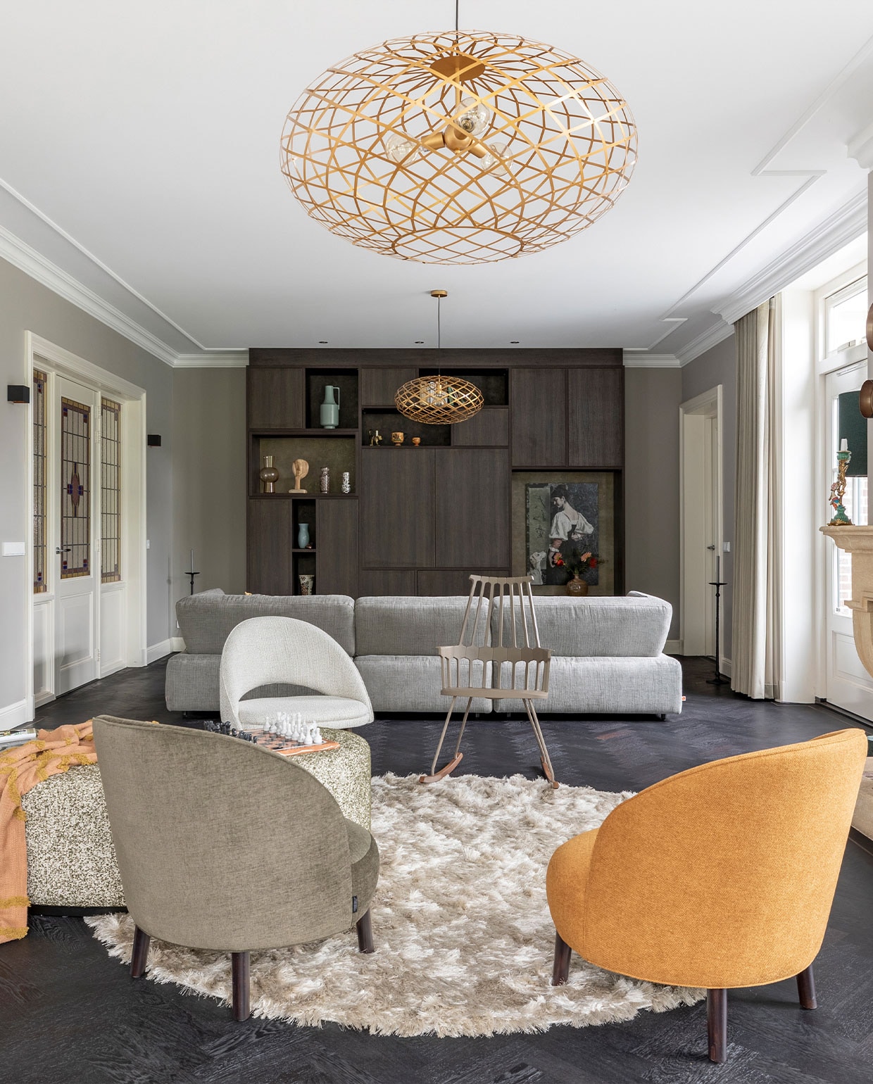 Schommelstoel Kartell van Comeback € 597,-, beige fauteuil Bend van Dôme Deco € 1130,-, fauteuils Bayron van Dôme Deco, per stuk € 1140,-, hocker Curve van Dôme Deco € 3100,-, plaid Fringe Pattern van HKliving € 39,95, grijze elementenbank Infinity van Jess Design € 5297,-, spiegelset van Dôme Deco € 239,-, hanglamp van Eijerkamp € 445,95 (eijerkamp.nl). Vogel op schouw van Pt € 27,96, kandelaar op schouw van Moos € 32,95, zwarte wandlampen Xio van Lucide € 32,25, hoge kandelaar Elida van Vestbjerg € 31,99 (vtwonen.nl). Tv-kast op maat gemaakt, prijs op aanvraag (woninginrichtingaanhuis.nl). Kunstwerk Vergulde vrouw op brokaat van Affect Fotografie € 1594,-, kunstwerk Where East meets West op mat staal van Affect Fotografie, in deze uitvoering € 445,- (werkaandemuur.nl). Vloer behandeld met Charcoal olie van Rubio Monocoat, prijs op aanvraag (parketservicealkmaar.nl). Overig zie foto 2 en 3 en privébezit. Weer verliefd op je huis herfst 2021 | Fotografie Margriet Hoekstra | Styling Frans Uyterlinde