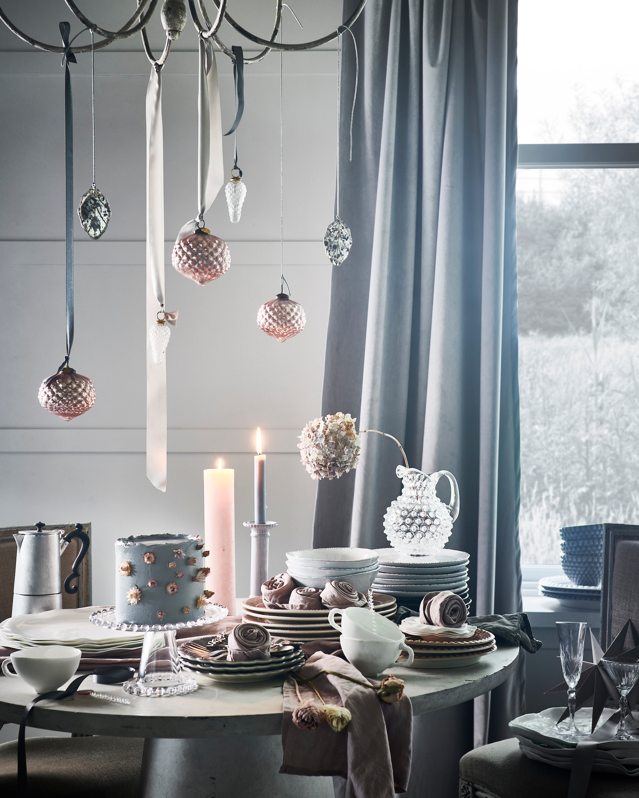 Taart, prijs op aanvraag (stickyflour.nl). Bloemen, prijs op aanvraag (tuinvanjudith.wordpress.com). Tafel € 439,- (basiclabel.nl). Antieke stoelen, per stuk (pietjonker.nl). Kroonluchter € 300,-, koffiepot € 70,-, glazen karaf € 70,- (paviljoennoord.com). Witte borden en kommen in organische vorm, per stuk vanaf € 19,75, wit porseleinen kopjes, per stuk € 24,-, zilveren gebaksvorken, per stuk € 8,50 (serax.com). Glazen plateau op voet € 14,99, witte kandelaar € 17,99, roze servetten, set van 2 € 9,99, witte terracotta kommen en borden met schulprand, per stuk vanaf € 7,99 (hm.com). Grijze borden in bloemvorm, per stuk € 22,50, roze borden met reliëfrand, per stuk € 29,50, roze ovale borden met schulprand, per stuk € 20,95, grijze ovale schalen met schulprand, per stuk € 49,50, grijze kommen met schulprand, per stuk € 32,50 (zwaanzinnig.shop). Roze kerstballen, per stuk € 4,99, zilveren theelepels met vogel, per stuk € 4,99, theelepel van gedraaid glas € 3,99 (sissy-boy.nl). Roze kaars € 14,- (allestedlund.com). Champagneglas € 7,99 (zarahome.com). Grijze papieren ster € 8,- (bungalow.dk). Kerstbal dennenappel € 4,95 (weldaad.com). Gordijn gemaakt van stof (wva.nl). Interieurontwerp Piet-Jan van den Kommer (vandenkommer.nl). JA | vtwonen 12-2021 | styling Danielle Verheul | fotografie Sjoerd Eickmans | Tuin van Judith (groenstylist), assistentie Niels Kist, Kula van den Broek