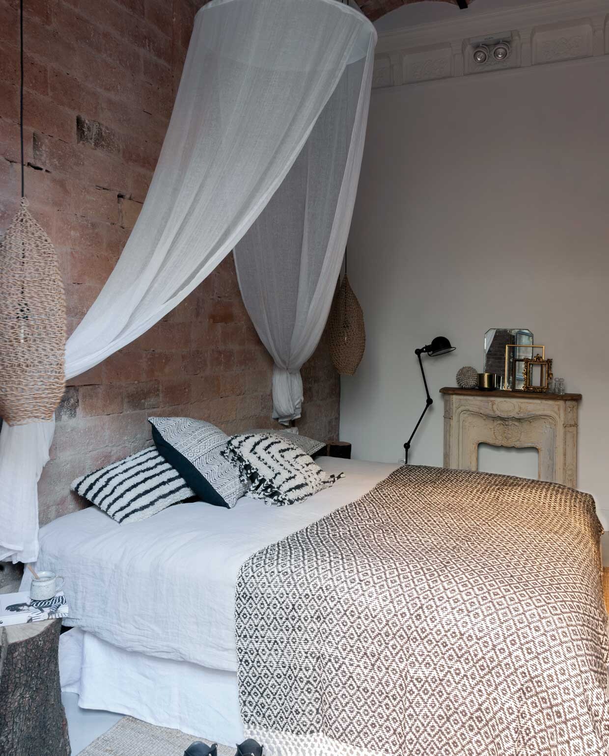 Beddengoed Bekume. De hanglamp is een ontwerp van Marta Castellano, de interieurdesigner die de bewoners heeft geholpen met de inrichting van het appartement. De hemel boven het bed zorgt ook hier voor een toefje wit.