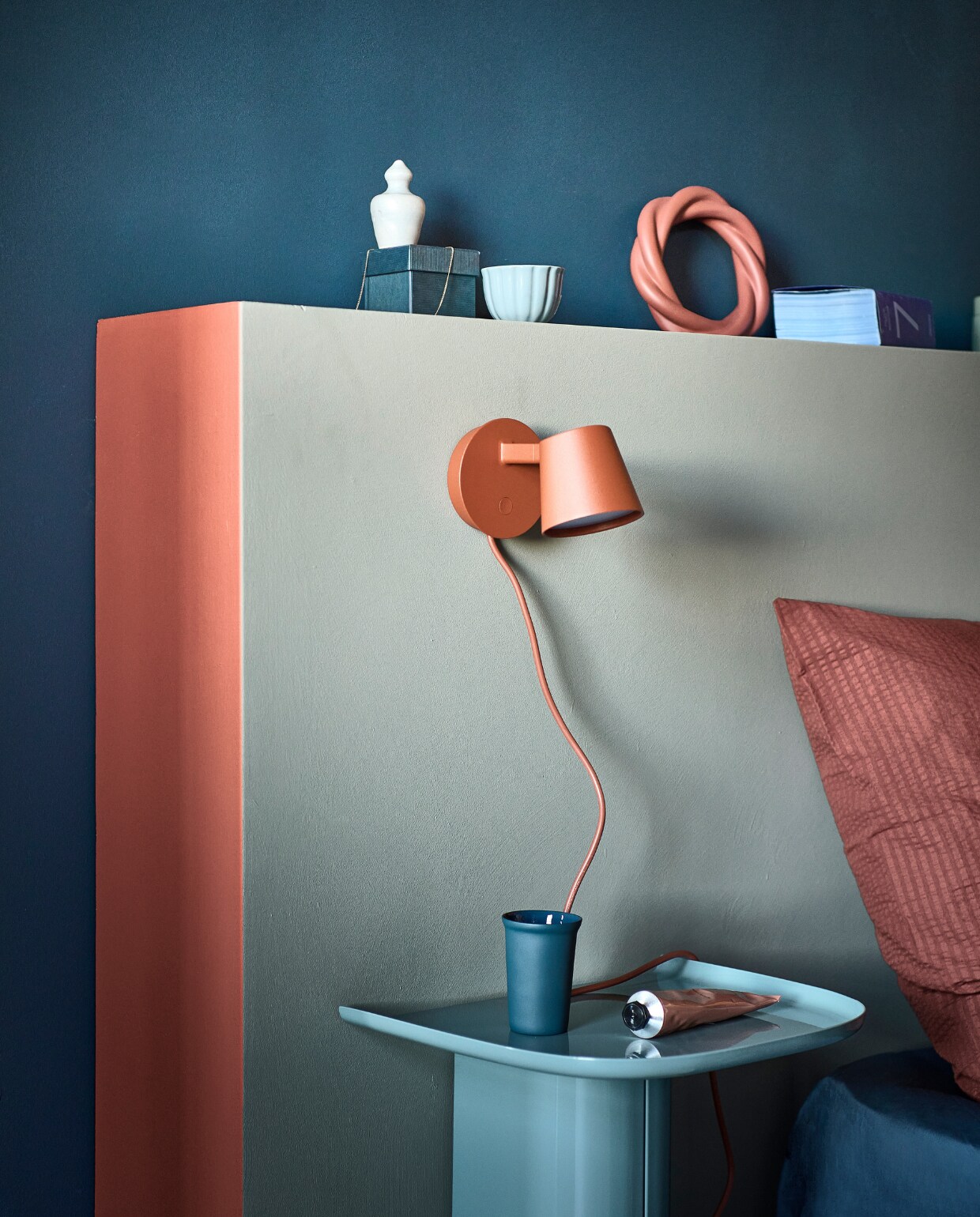 Muurverf hoofdbord Soap, zijkant hoofdbord Red Earth, achterwand Denim van vtwonen, 1 liter € 23,99, 2,5 liter € 39,99.M.m.v. muuto.com (wandlamp), dumu.nl (donkerblauwe mok), sissy-boy.com (ringornament), zarahome.com (handcrème), hm.com (blauwe espressokop). Overig privébezit.