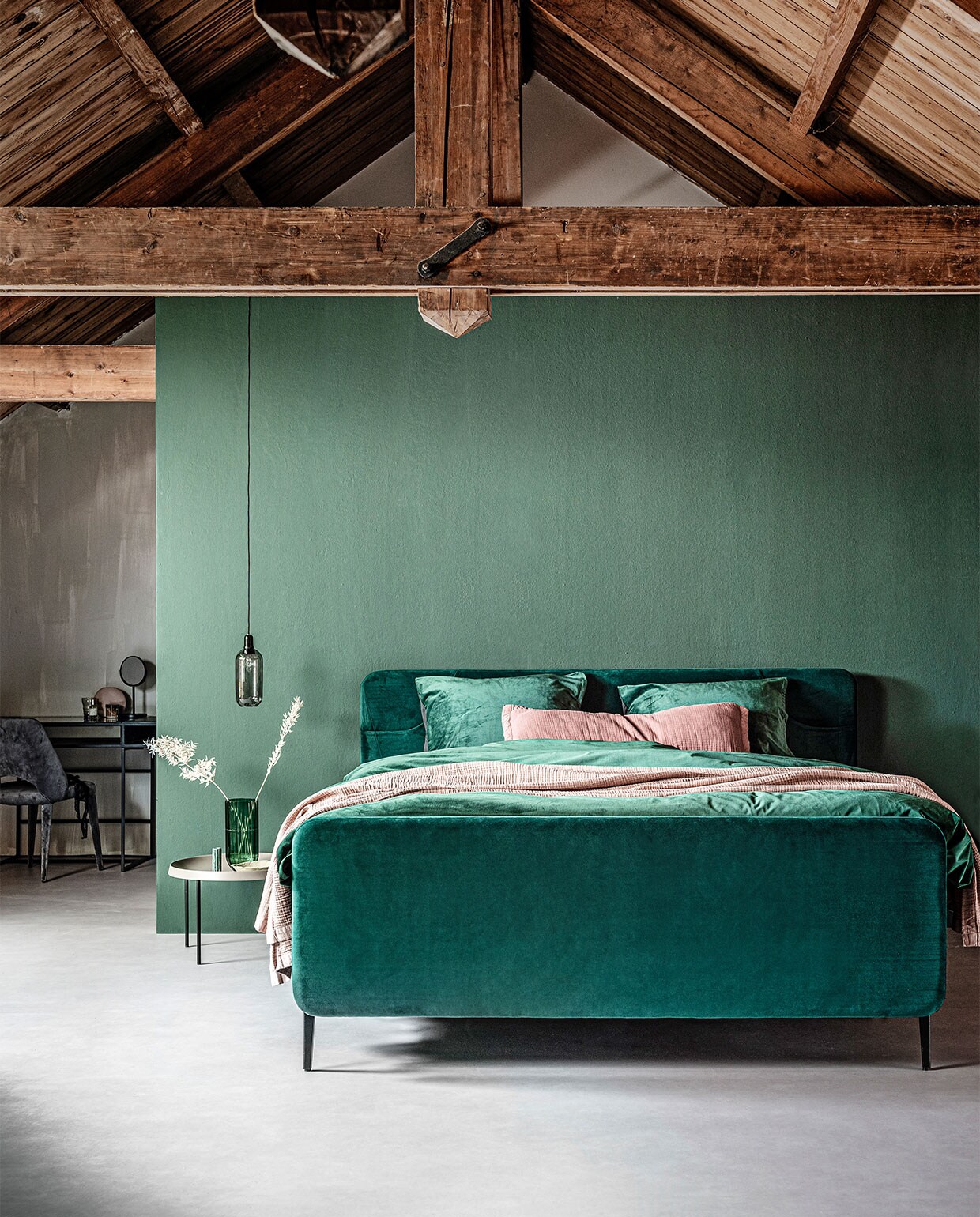 Boxspring Basil inclusief voetbord in stof Glory in kleur Bottle Green, zwart metalen frame en poot Track, 140×200 cm (bxl) vanaf € 1690,-.M.m.v. karwei.nl (muurverf Bottle van vtwonen), vtwonen.nl/vtwonen-collectie (dekbedovertrek, roze plaid, roze sierkussen, staande spiegel), loods5.nl/design (bijzettafel, hanglamp, platte roze vaas), loods5.nl (groene schaal blad), klevering.nl (groene marmeren kandelaar, groene glazen vaas), polspotten.nl (bureau, fluwelen stoel). Overig privébezit.