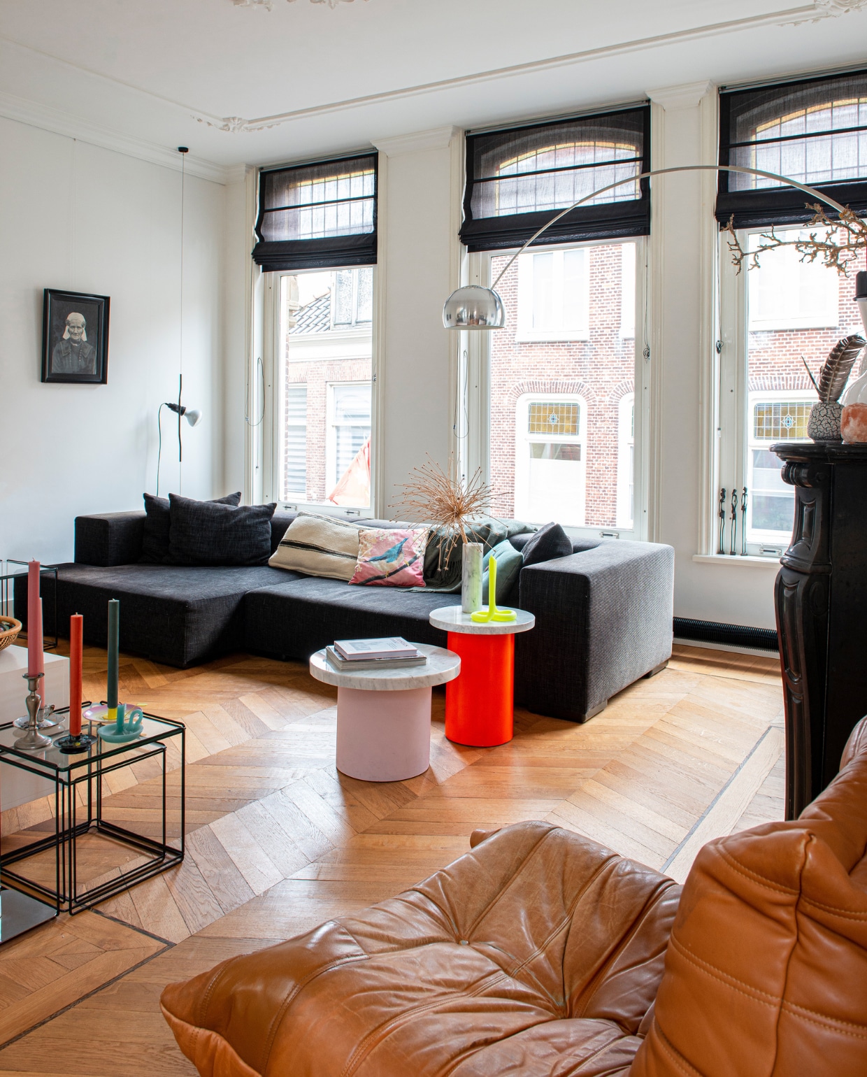 Plafondornamenten Het Schippertje, booglamp Arco en hanglamp Parentesi van Floss, kussens Household Hardware en de Bijenkorf, vintage bijzettafels Isocele Nesting Tables van Max Sauze kringloopwinkel, dinerkaarsen Petit Depot, ronde bijzettafels met marmeren blad zelfgemaakt, kaars Twist van Lex Pot via Kunstcentrum Haarlem, fauteuil Togo van Ligne Roset via Marktplaats, houten vloer van verouderd eiken zelf gelegd in Hongaarse punt, portret van voorouders, raambekleding Bece, bank onbekend.