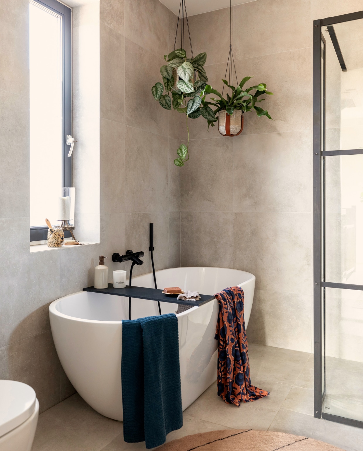 Bad, douchewand, kranen Sanitairkamer, tegels Tegelsinhuis, plantenhangers Madam Stoltz, zeeppomp en blauwe handdoek H&amp;M Home, luipaard Anna &amp; Nina, windlicht Intratuin.