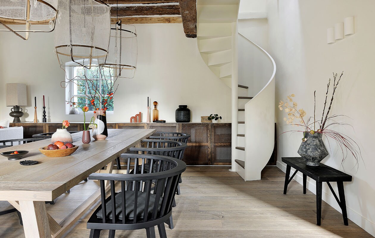 Tafel Arundel Neptune. Stoelen Bridge Gray Paola Navone voor Gervasoni. Lampen Z1 Black Ay Illuminate. Grote vaas op tafel en tafellamp HKliving. Lage vaas Fusion Muskhane. Houten schaal Rochel Habitat. Kandelaren Kinta Atelier Germain. Karaf gerookt glas en boogkaars Fleux. Zwarte vaas Passage Vernet. Bankje H&amp;M Home. Vaas Greek Terracotta 101 Copenhagen. Overig onbekend.
