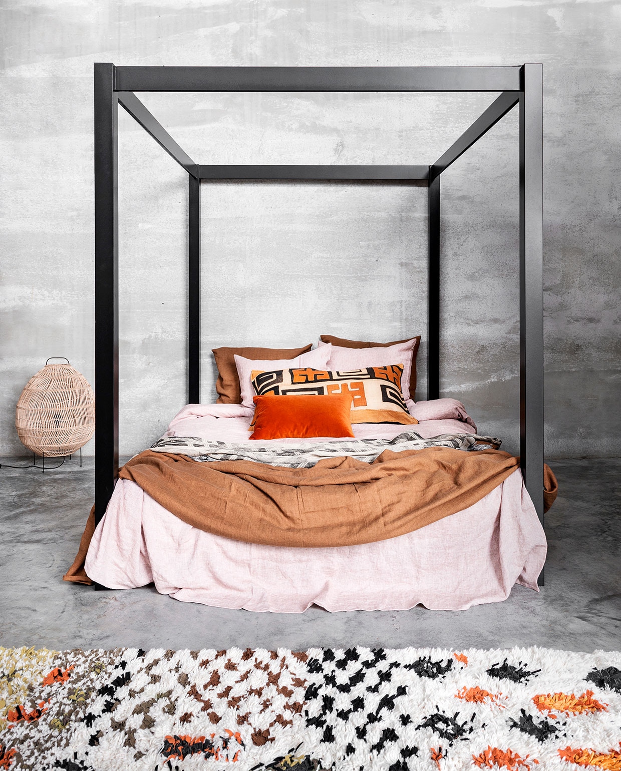 Hemelbed vanaf € 350,- (Combitex). Dekbedovertrekset van linnen in kleur Pink Salt en Cinnamon, 140×200 cm € 129,- (By Mölle). Plaid Belem van linnen en zijde in transparant bruin/naturel € 74,-, kussen van oude raffia Kuba kleden vanaf € 165,- (ML Fabrics). Oranje velours kussen € 60,- (Pols Potten). Rieten lamp € 349,- (HK Living). Vloerkleed van Madam Stoltz, 180×120 cm € 392,- (Deens).