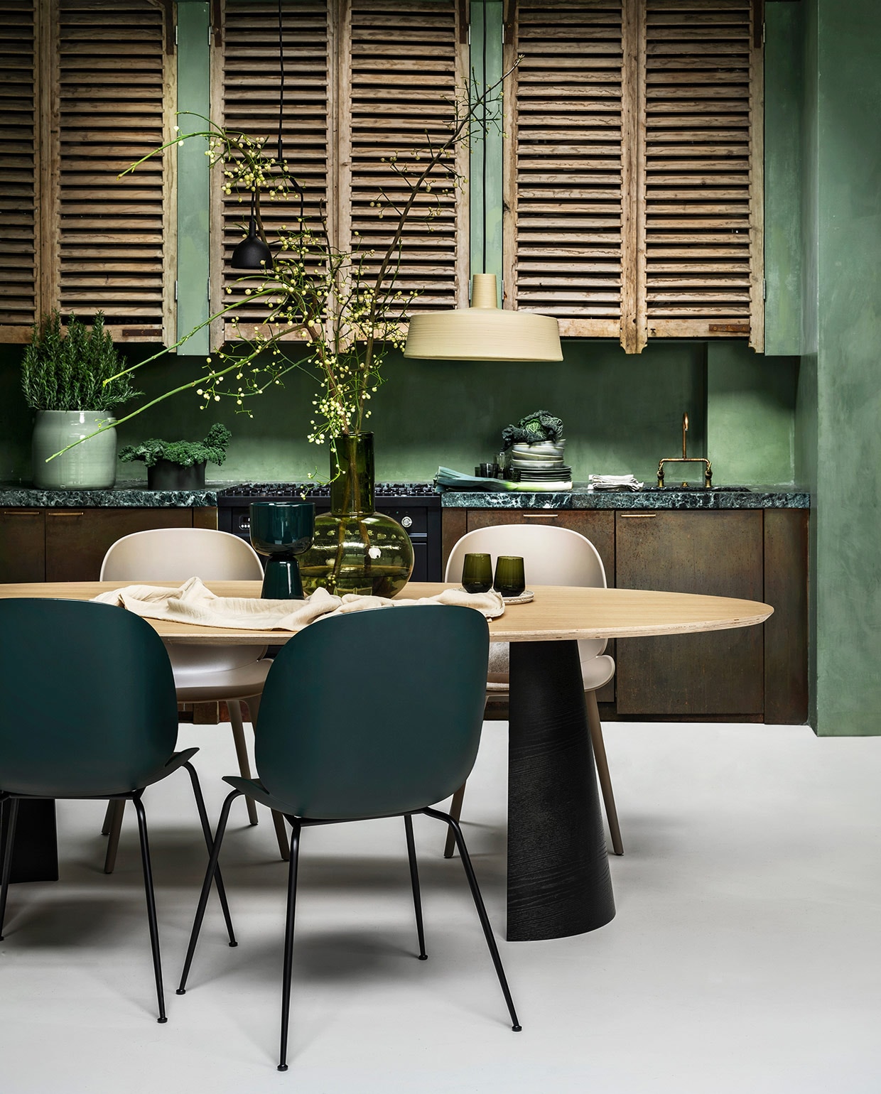 Eikenfineer tafel Arp, 260x120x75 cm (lxbxh) € 2225,-, lichtgroene pot € 83,05 (loods5.nl). Stoelen Beetle en Bat in zand en mosgroen van Gubi vanaf € 349,-, zwarte hanglamp van Menu € 249,-, zandkleurige hanglamp van Marset € 574,-, groene glazen vaas van HKliving € 99,95, linnen tafelkleed van vtwonen € 79,95 (vtwonen.be). Ingelijste textielkunst Fant € 495,-, keramieken borden en schaal vanaf € 35,- (sukha.nl). Donkergroene aardewerk pot op voet € 69,-, groene waterglazen per 2 € 64,90, donkergroene schaal op aanrecht € 99,- (iittala.com). Borden vanaf € 9,95 (hkliving.nl). Messing keukenfronten prijs op aanvraag. (juliusballer.nl). Marmeren aanrechtblad prijs op aanvraag (janreek.nl). Louvre panelen prijs op aanvraag. (burbri.nl). Koperen kraan prijs op aanvraag (oudebouwmaterialen.nl). Kalkverf Lagune, per liter € 48,- (cartecolori-dialma.nl). Overig privébezit.