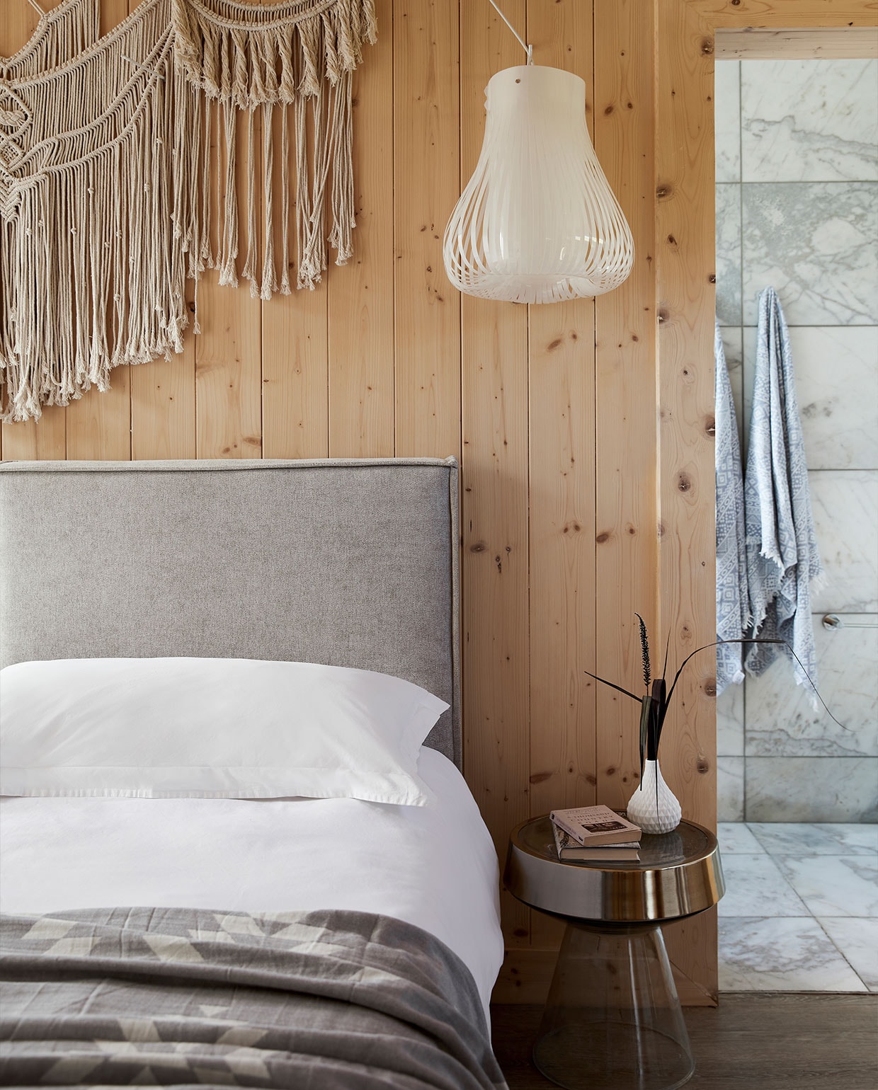 Op maat gemaakt bed en hoofdbord Giraffe Designs. Beddengoed Lifsons en White House. Plaid The Cotton Company. Bijzettafel Weylandts. Hanglampen Eurolux. Wandhanger No Negative.