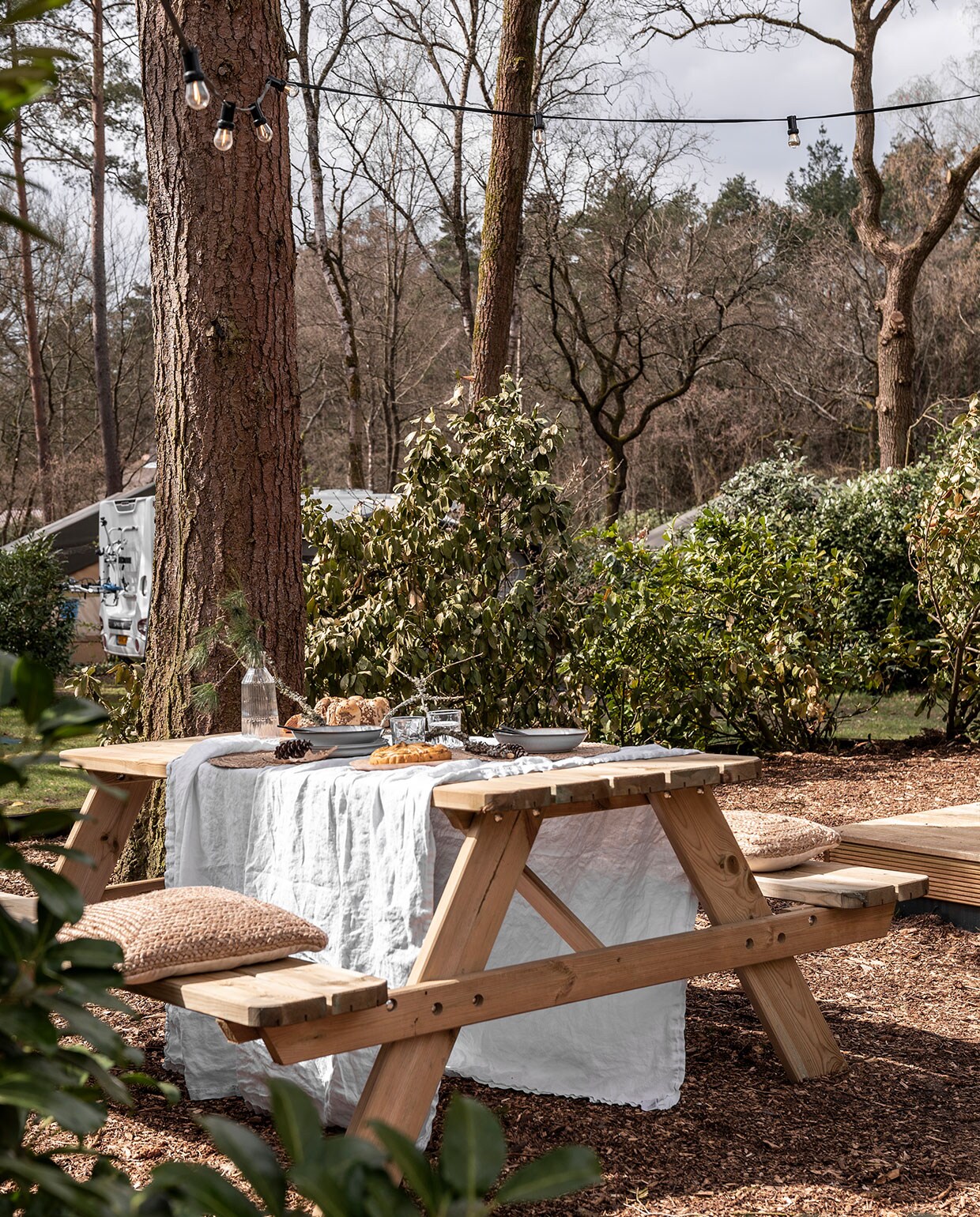 Picknicktafel herkomst onbekend, kleed H&amp;M Home. Servies, karaf, glazen Ikea. Kussens Calma House, lampenslinger Marktplaats.