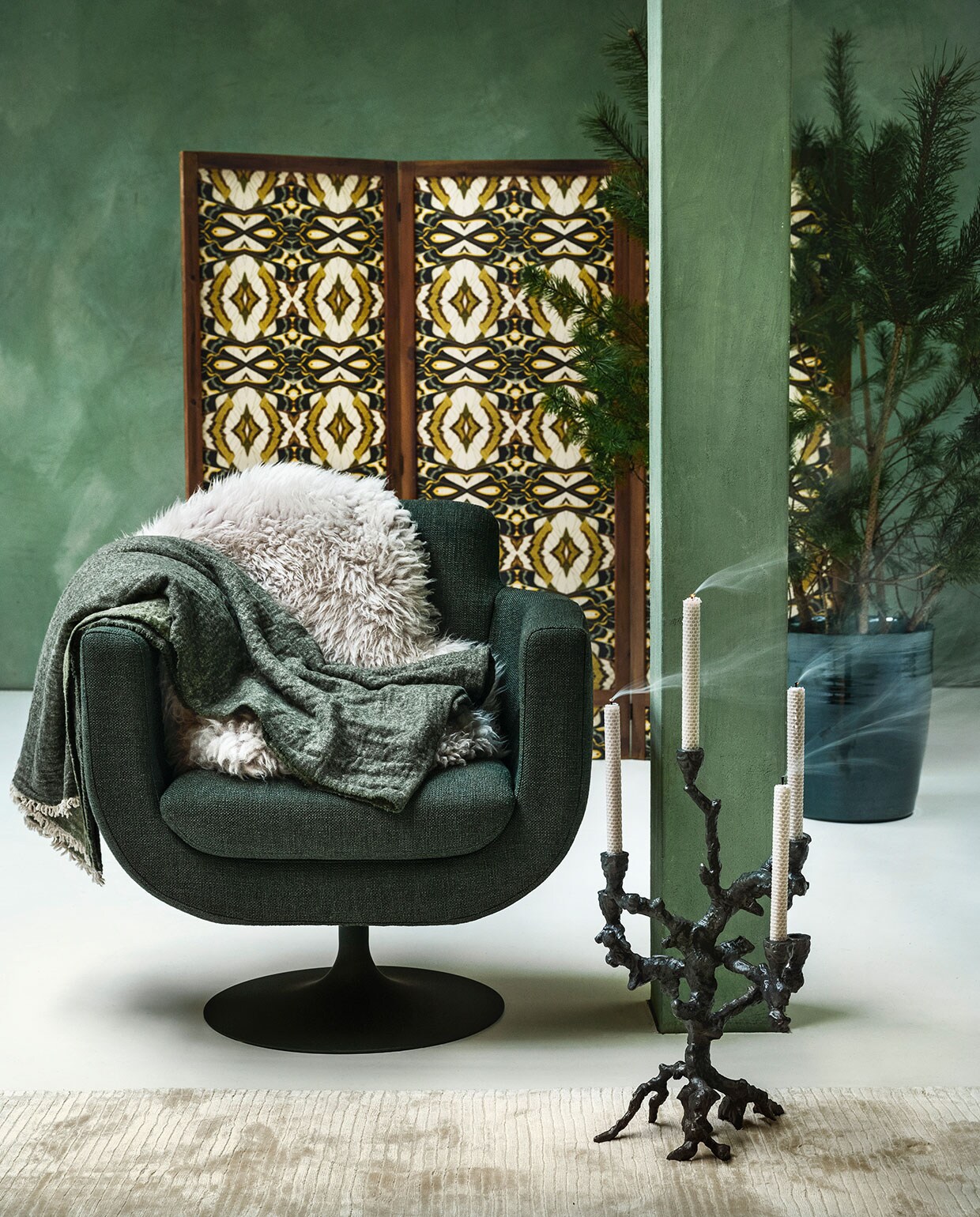 Fauteuil Swivel Kirk € 1385,-, schapenvel € 135,-, kandelaar € 215,-(polspotten.nl). Linnen plaid € 99,95 (vandyckshop.nl). Laagpolig vloerkleed prijs op aanvraag (hkliving.nl). Pot € 155,- (loods5.nl). Panelen prijs op aanvraag (com-anders.nl), met daarop behang Casca Belle, per rol € 99,95 (artwallcollection.com). Kalkverf Lagune, per liter € 48,- (cartecolori-dialma.nl).