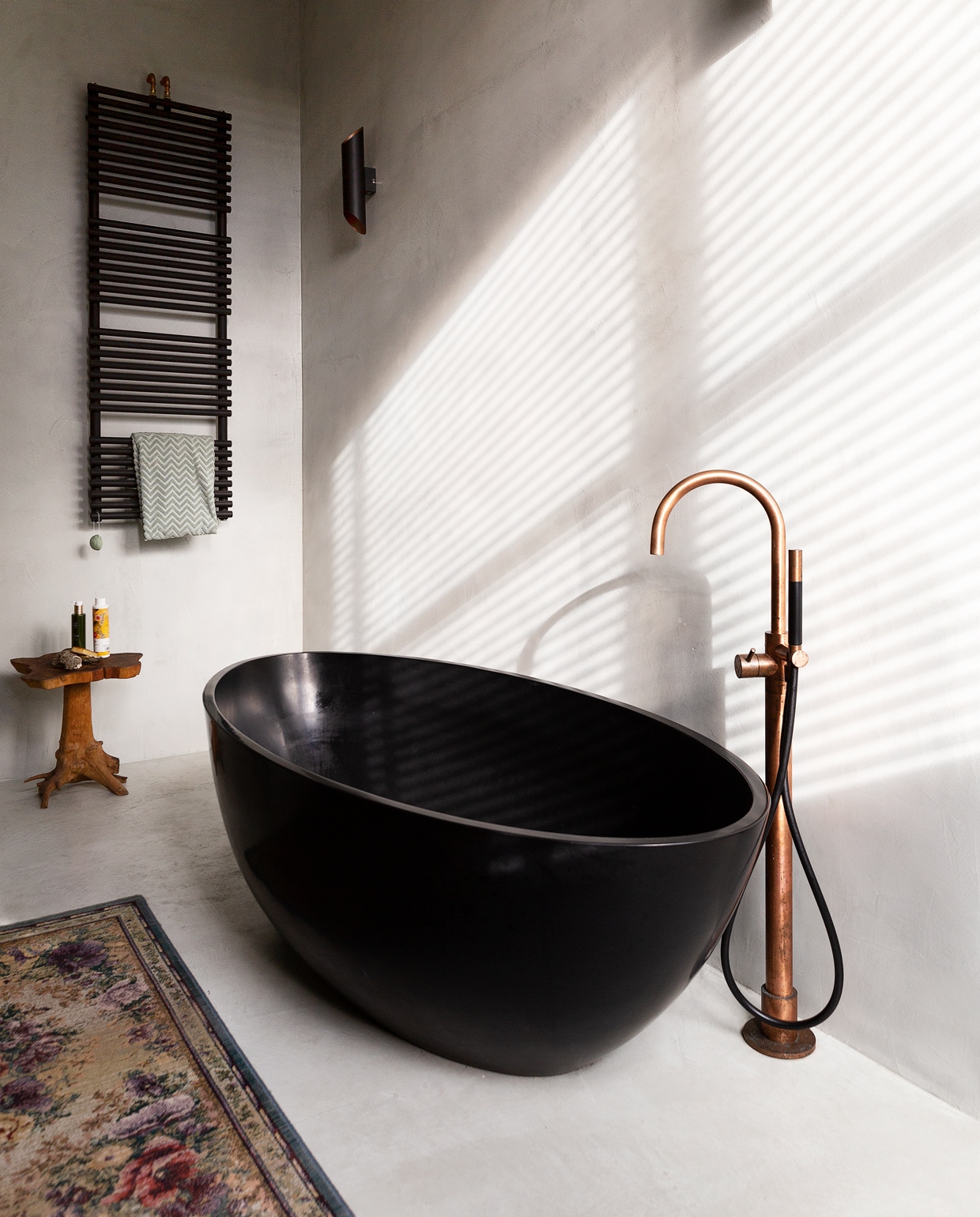 Vrijstaand bad Sol Garden mat black Sanitair online. Kraan Hotbath, Meester Smeets. Kruk Loods 5. Wandverwarming Hudson Reed. Wandlamp Agolada, Eglo. Voerkleed Otto.