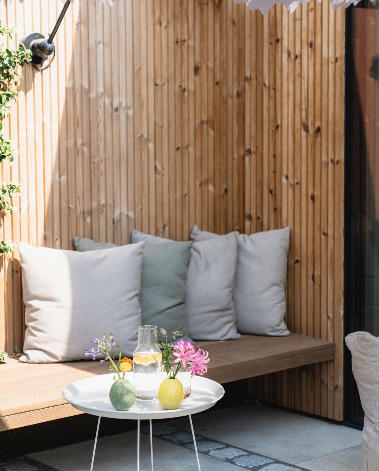 Latten rondom het huis thermo pine design rabat. Bijzettafel Fatboy. Gele en groene vaas bloemenwinkel Jasmijn.