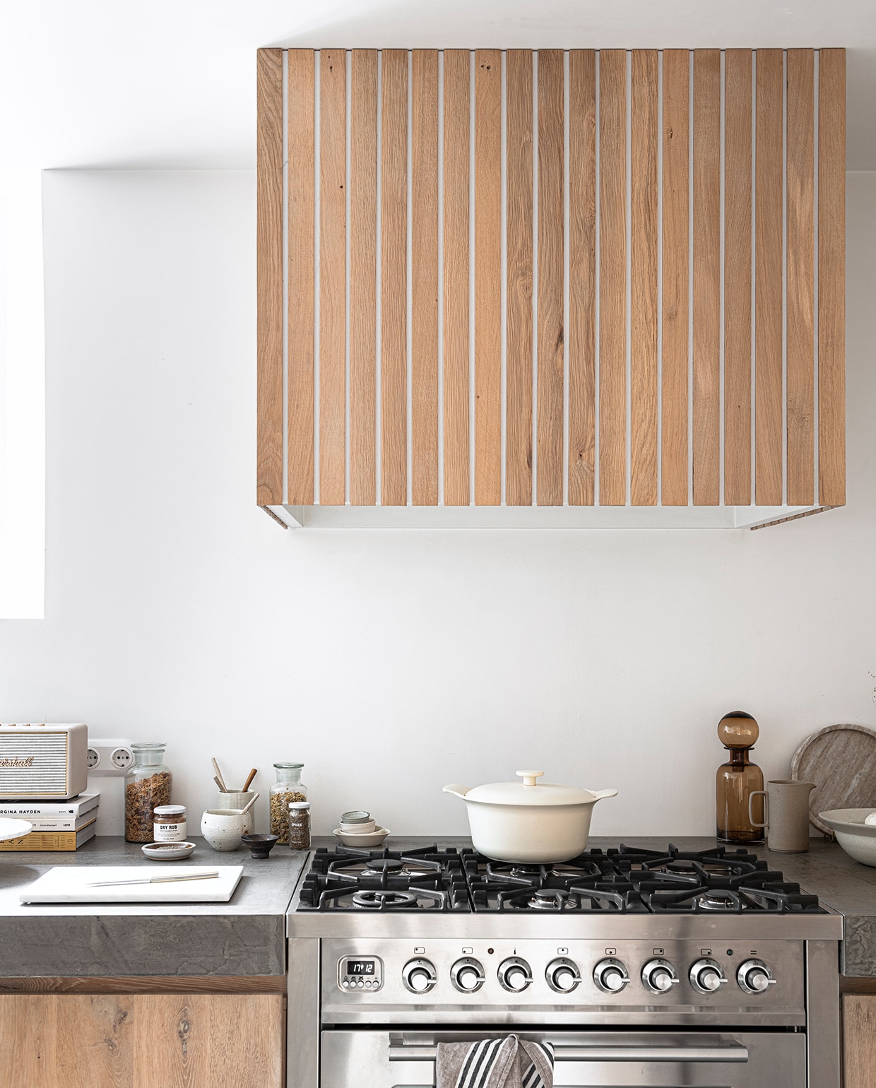 Grote vaas, pan, kom, geruite shopper (zarahome.com). Marmeren dienblad, marmeren snijplank, marmeren taartplateau, linnen schort (hm.com). Bruine glazen karaf met bol-dop (loods5.nl). Kleihanger (ohmyhome.nl). Keuken op maat gemaakt (fredconstant.nl). Overig privébezit.