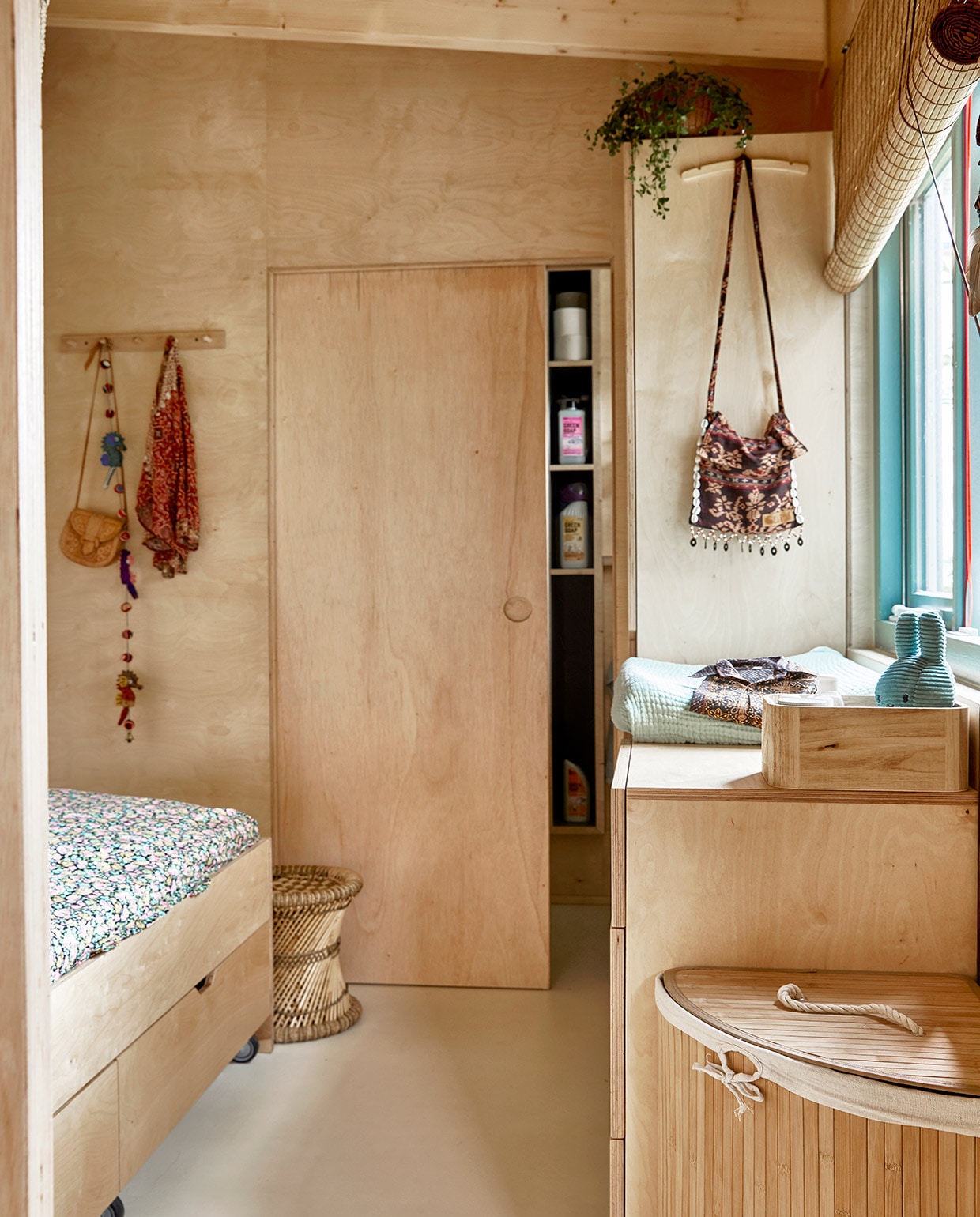 Rieten kruk herkomst onbekend. Beddengoed H&amp;M Home. Leren tasje en kledingstuk souvenir uit Indonesië. Slinger Tastoe. Bruine tas Curms. Aankleedkussen Hema. Houten bakje Kwantum. Nijntje Tastoe. Wasmand Relaxdays. Bamboe rolgordijn Leen Bakker.