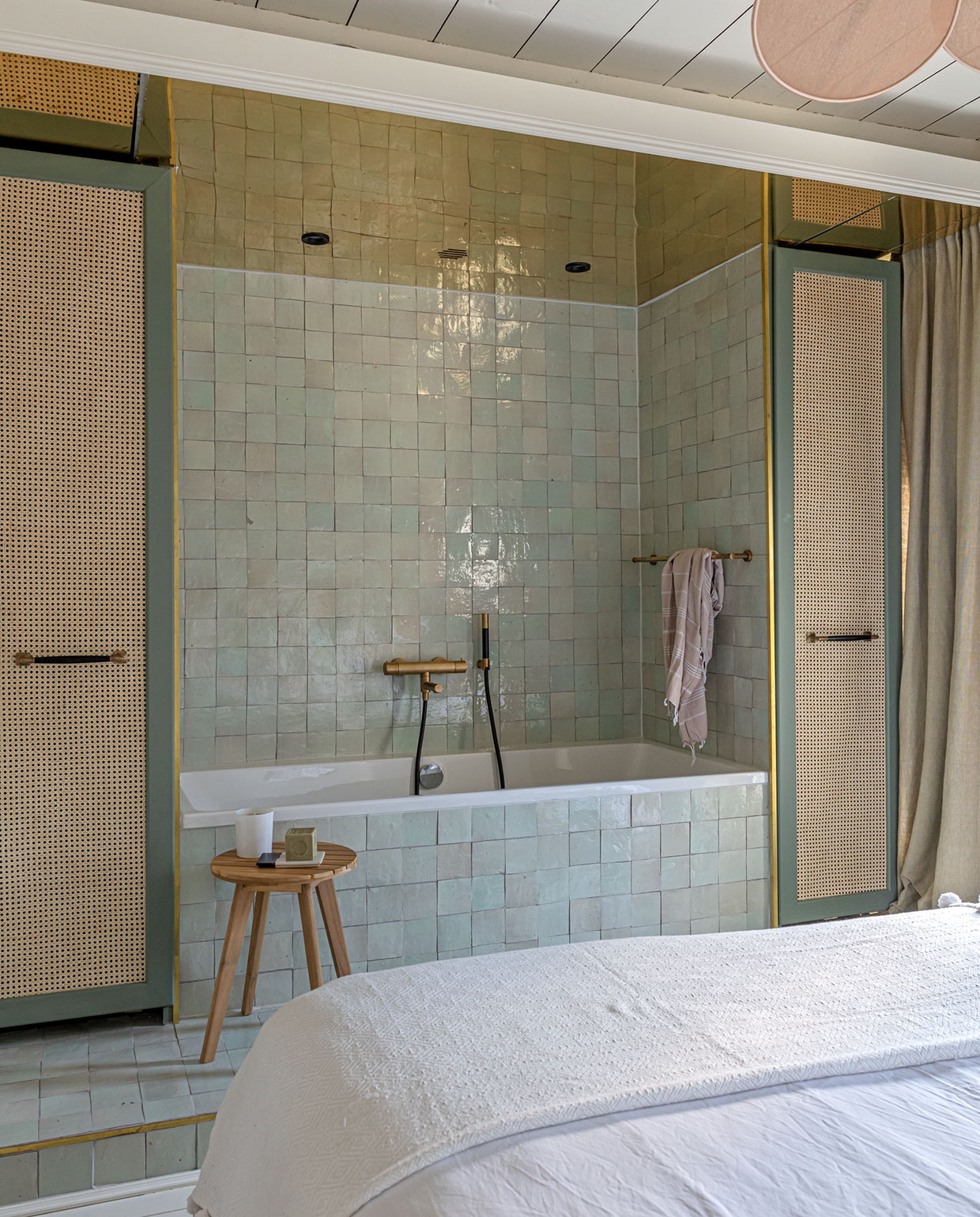 Kasten zelfgemaakt. Messing plafond Plaatopmaat.nl. Tegels Zellige in, kleur Vert Clair Designtegels. Kranen en handdoekrek Hotbath. Hamamdoek Rozenkelim. Kruk Kwantum, geurkaars Rituals. Beddengoed Four Leaves.