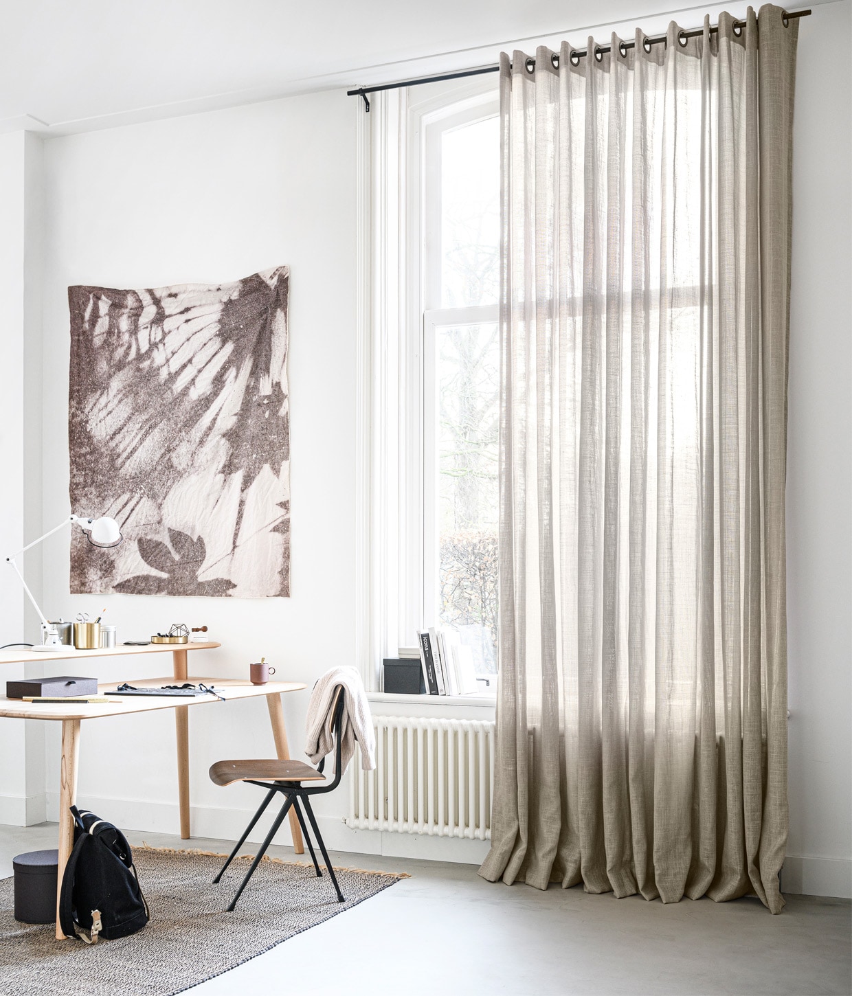 Gordijn in stof Vlas kleur 1150 (verkrijgbaar bij Karwei), M.m.v. demachinekamer.nl (bureau Olger van Sav &amp; Økse), blooming-label.com (wandkleed Quiet Resource), loods5.nl (stoel Result van Hay, gouden opberger), extravert.nl (bureaulamp), ikea.nl (ronde doos, langwerpige doos, doos in vensterbank, blik met deksel), hkliving.nl (mok), studione9en.nl (wollen trui van Second Female), sandqvist.com (rugzak), hm.com (vloerkleed). Overig privébezit.