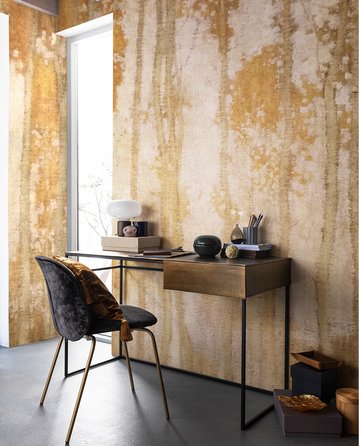 Behang Sentieri (glamora.it). Bureau (polspotten.nl). Stoel (covanderhorst.nl). Kussen gemaakt van stof Infinity (eijffinger.com). Lamp van New Works (vtwonen.nl). Dozen, blauwe glazen opberger met deksel, zachtroze glazen knoop, schriften in blauw en bruin, zandloper, pennenhouder, potloden, schaar, gele glazen schaal in de vorm van een schelp (hay-amsterdam.com). Clipboard(loods5.nl). Ronde keramieken opberger, leren opberger (hm.com). Overig privébezit.