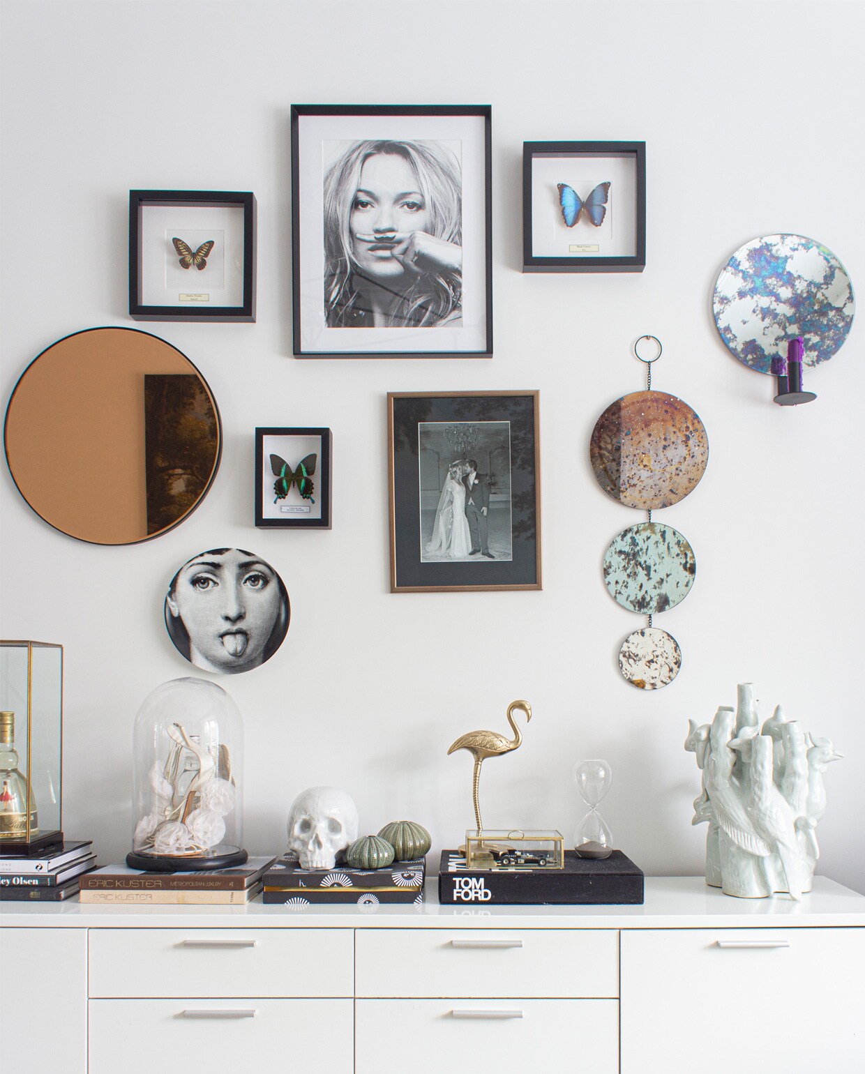 Spiegels Zara Home, Yaya en Ferm Living. Vlinderlijstjes Stenelux, Kate Moss Wallified, trouwfoto Angela en Jos. Bord Fornasetti marktplaats.nl, vogel Karwei, groene vaasjes Madam Stoltz, vaas en schedel Pols Potten, onder de stolp Angela’s trouwschoenen. Kast wehkamp.nl.