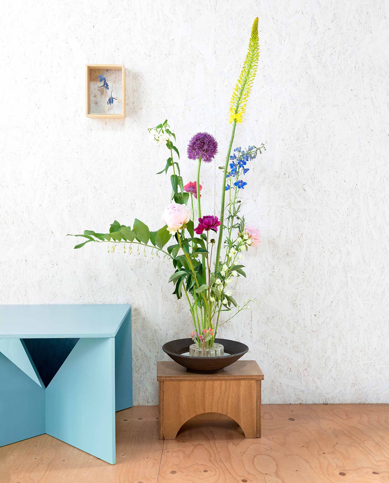 Kunstwerk ontworpen door Saskia de Valk (). Bijzettafel Calvert (). Vaas Bloom Block en schaal (). Krukje privébezit.,