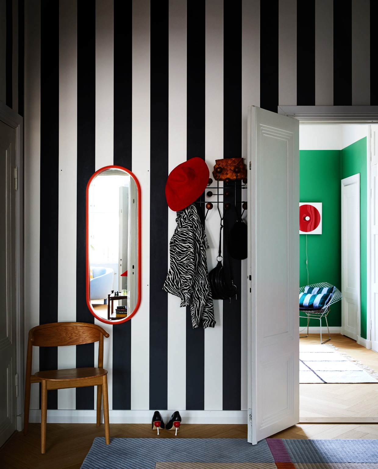 Behang Rand Sandberg. Spiegel Bonbon en stoel Mama Hakola. Kapstok Hang It All Vitra. Vloerkleed xxxxxx. Rode wandlamp w153 Île Inga Sempé.