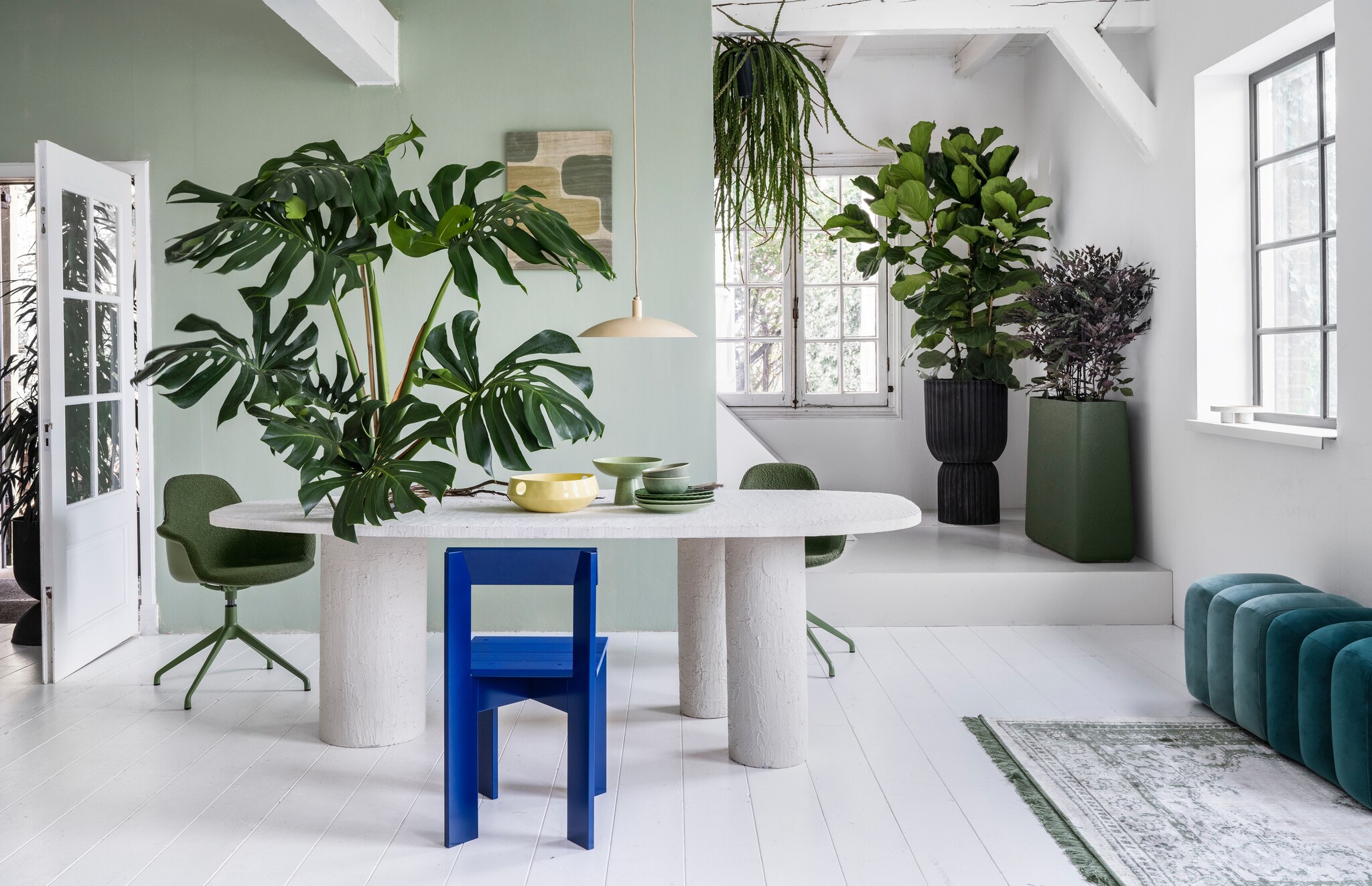 vtwonen 03 2023, groen | Plant op tafel Monstera € 195,-, hangplant Rhipsalis € 44,95, plant achter Ficus Lyrata € 195,-, pot, 45x88 cm (Øxh) € 295,-, plant Hami € 75,-, pot, 80x25x80 cm (bxdxh) € 495,-, achter de openslaande deur treurvijg € 125,- (bydennis.nl). Muurverf in nr. 58 van Lab Paint, 1 liter € 48,- (vestingh.nl). Tafel, prijs en maat op aanvraag (com-anders.nl). Vloerkleed van Zuiver, 240x170 cm, hanglamp van Urban Nature Culture € 119,- (vtwonen.be). Draaibare stoel Albert Kuip € 349,- (zuiver.nl). Houten stoel Ark Chair van Ferm Living, 40x78x45,5 cm € 199,- (flinders.nl). Zitelementen € 215,- (loods5.nl). Wandkleed € 81,80 (urbannatureculture.nl). Keramieken geribbeld bord, set van 2 € 22,99,-, gespikkelde dinerborden, set van 2 € 26,99, groene keramieken schaal op voet van HKliving € 54,95 (vtwonen.be), gele fruitschaal van Urban Nature Culture € 59,95 (urbannatureculture.com). vtwonen 03 2023 | styling Marianne Luning | fotografie Stan Koolen