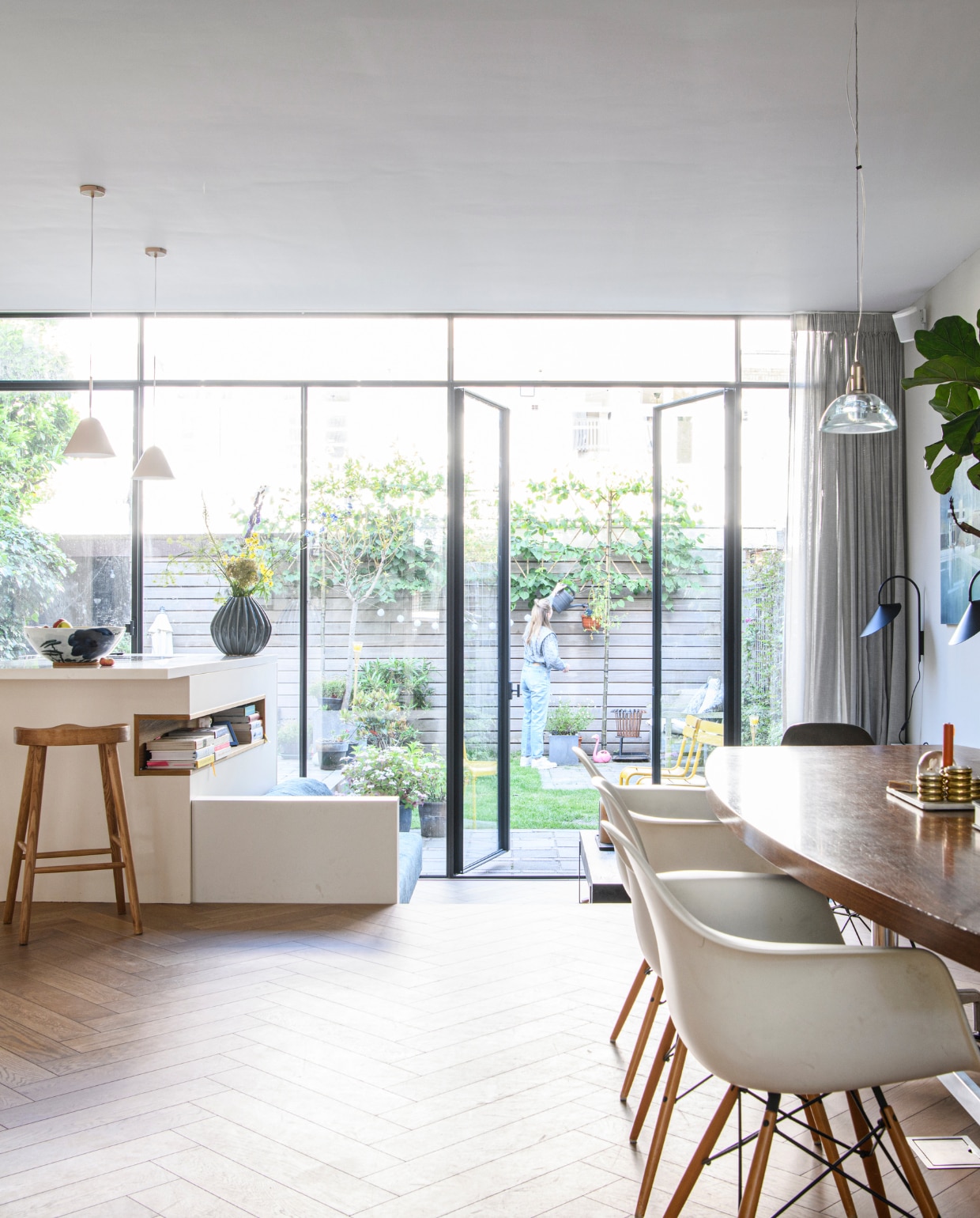 Tafel Neef Louis, eetkamerstoelen Shell Chairs van Eames voor Vitra. Hanglamp Galileo van Lumina. Muurlampen Ferm Living, schilderij Jan Ros, bank en salontafel Atelier Blender, kussens La Redoute, gordijnen Kniphal Amsterdam, lamelparket L’intérieur Traditionnel. Keuken Atelier Blender. Hanglamp La Redoute, krukken Zara Home. Overig onbekend. vtwonen 04-2023 | productie Insidehomepage | styling Inge van Lieshout | fotografie Louis Lemaire