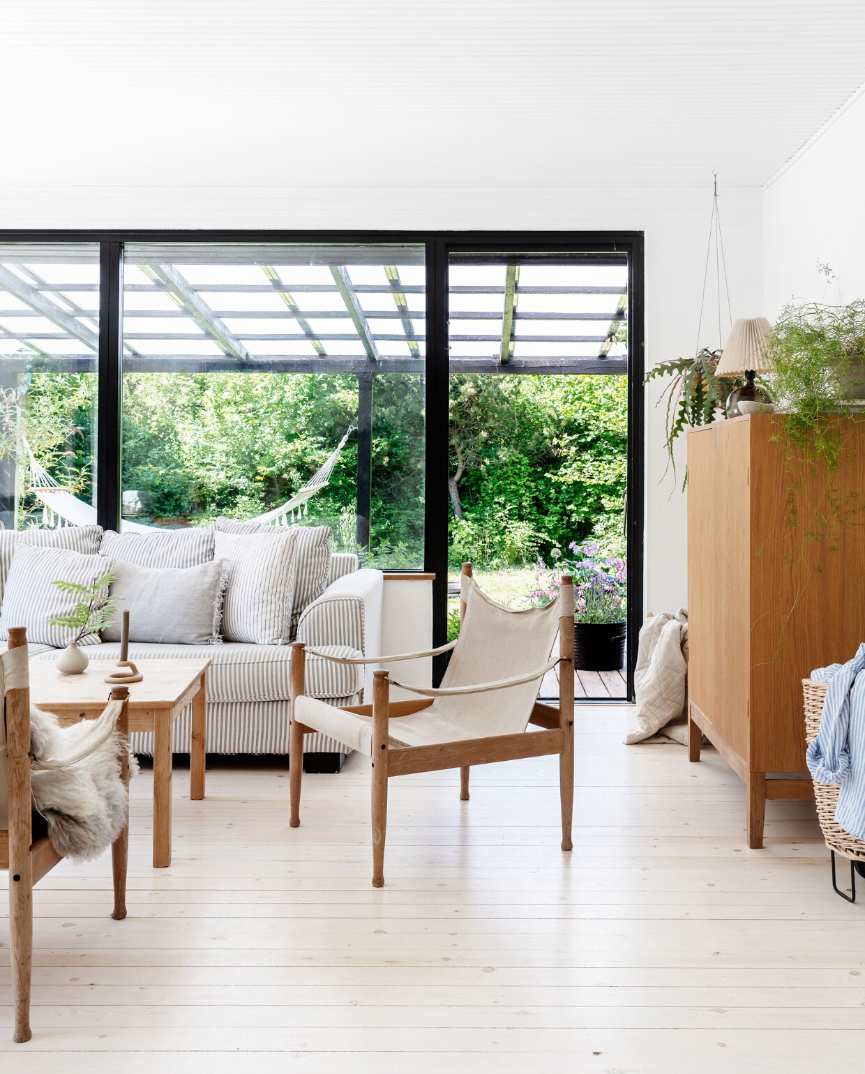 Bank Ilva, tweedehands gekocht via de Deense Marktplaats DBA. De salontafel stond al in het huis. Stoelen en Gotland-schapenvacht vlooienmarkt. vtwonen special binnenkijken 06-2022 | productie Living Inside | Styling Rikke Graff Juel | fotografie Christina Kayser O.