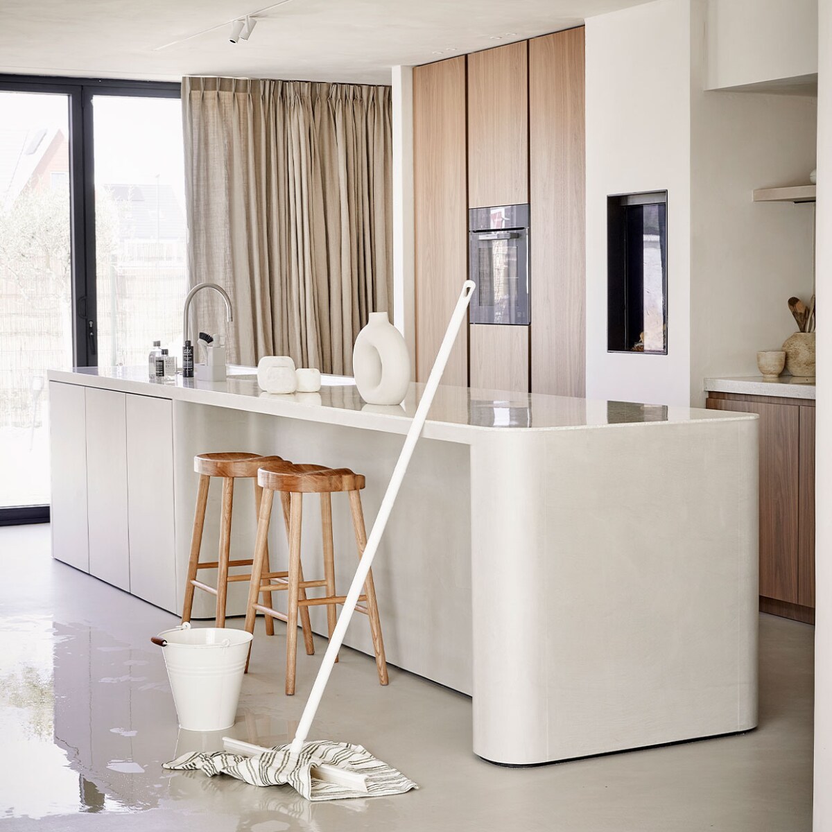 Keuken dweilen en schoonmaken. Vloertrekker- wit – 40 cm + Steel 130 cm – €49,95 (Vikan), Dweil van katoen – wit/olijfgroen gestreept – 60 X 60 cm – €6,95 (Dille &amp; Kamille), Emmer – zink – offwhite – 10 L – € 9,95 (Dille &amp; Kamille), Singles afwasset 4-delig – grijs – €45, (Zone Denmark), Styling Studio Marit Saladini, Fotografie Peggy Janssen | stylingassistentie Paolo Rosetin