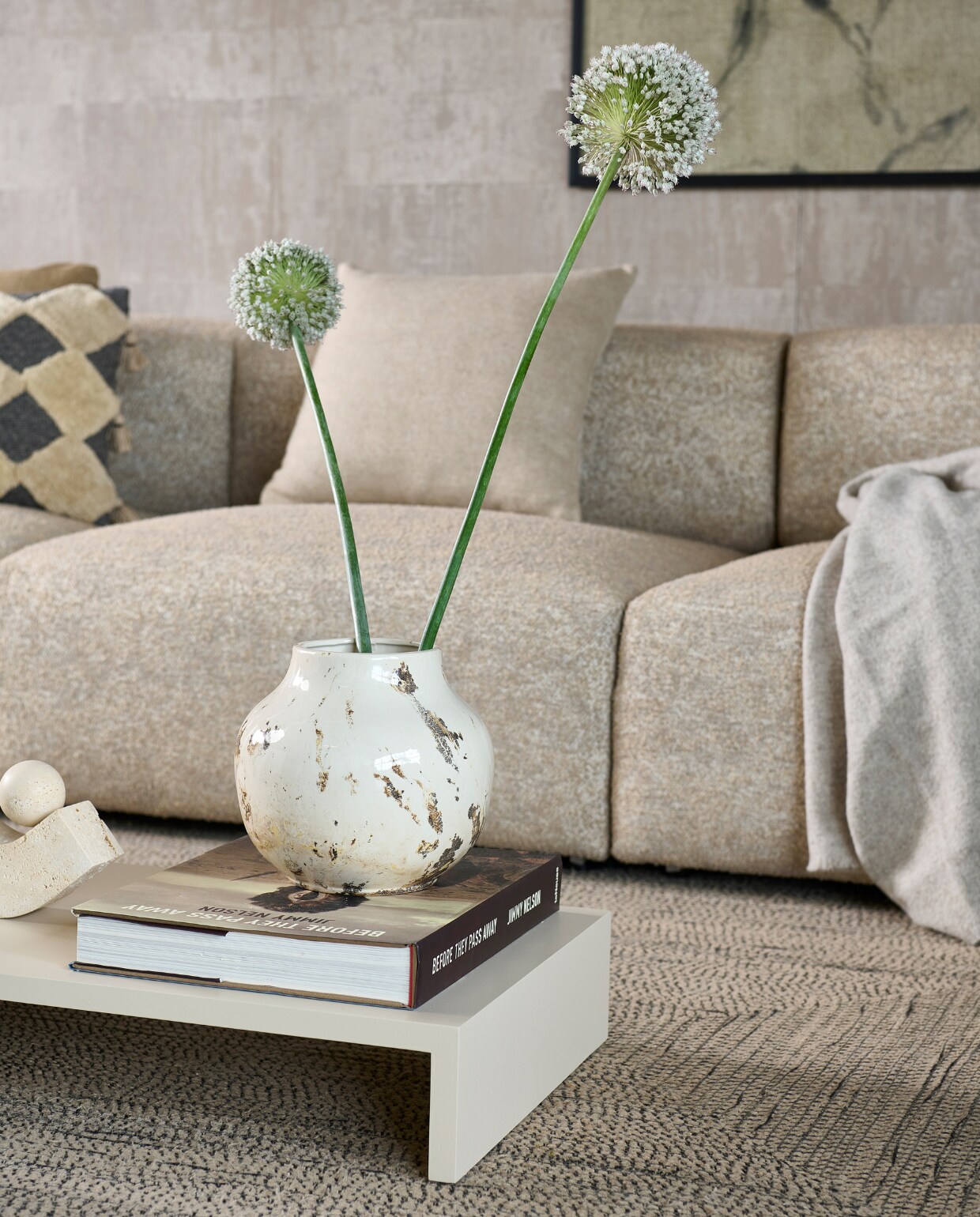 Elementenbank Cubi Sectional Open End van Basta in Warm Grey Melé € 3490,- (basta.co). Vinylbehang Atelier d’Artiste VP88077 van Élitis, 10x1 m (lxb), per rol € 225,-, sisal vloerkleed Disco van Élitis, gerecyclede petflessen, 250x350 cm € 2500,- (loggerewilpower.com). Ingelijst portret € 1500,- (gracespiegel.com). Houten bijzettafels Plateau S en M van HKliving in Sand € 179,- en € 225,-, aardewerken vaas Mias van Bloomingville € 37,90, keramieken vaas Janka van Bloomingville € 89,99, katoenen kussen Elina van Bloomingville € 54,90, wollen kussen Double Faced van Malagoon € 49,95 (vtwonen.nl/shop). Kussen Dot in Camel, katoen en linnen € 115,-, wollen deken Mono in Creme Melange € 115,- (hay.nl). Travertin boeken- steun Equi van Caché € 297,- (loods5.nl). vtwonen 2023-11 | Styling Marianne Luning | Fotografie Sjoerd Eickmans