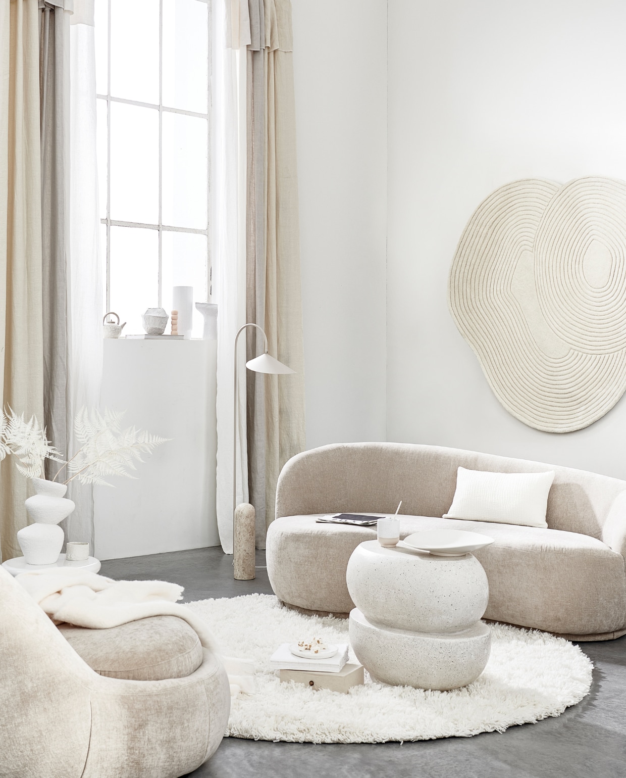 Fauteuil, 176x100x74 cm (bxdxh) € 599,-, bank € 999,- (sofacompany.com). Gordijnen gemaakt van linnen stof Brera Lino in kleur Calico, Putty en Oyster van Designers Guild, per meter € 86,- (wva.nl). Vloerkleed van Linie Design € 700,-, bijzettafel van Pols Potten € 294,99, vloerlamp van Ferm Living € 679,- (vtwonen.nl). Wollen plaid € 119,-, keramieken theepot € 25,99, kussen € 39,99 (zarahome.nl). Keramieken vaas € 29,99 (hm.com).Keramieken mok € 22,90 (letoile.store). Geometrische vaas en schaal op voet prijs op aanvraag (julyadrichem.com). Handgemaakte bolletjeskaars, set van 3 € 45,- (sukha.nl). Porseleinen vaas € 87,-, vloerkleed aan wand € 630,-, witte keramieken mok met ongeglazuurde onderkant, set van 2 € 27,- (bolia.com). Betonnen bijzettafel € 450,- (lanena-home.com). Keramieken schaal € 44,95 (urbannatureculture.com). Overig privébezit. vtwonen 05-2022 | styling Danielle Verheul | fotografie Sjoerd Eickmans