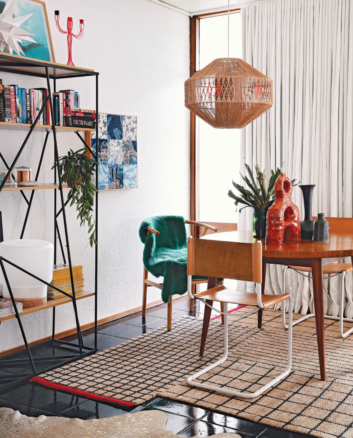 Vintage eettafel via Tonic Design. Stoel Wishbone Carl Hansen &amp; Son, overige stoelen Pezula Interiors. Groene schapenvacht Woodheads Cape Town. Rood, keramieken kunstwerk Ben Orkin, overige keramiek Anthony Shapiro. Hanglamp lokaal gekocht, die Kerryn versierde met oranje draad. Vloerkleed Ikea. Wandkast Mobelli. Witte ster Folha Plant Shop. Oranje kandelaar After Noah. Tafellamp Sinnerlig Ikea. Kunstwerk van Varenka Paschke. Overig onbekend. vtwonen binnenkijkspecial 07-2021 | productie Luanne Toms/Frank feautures | fotografie Elsa Young