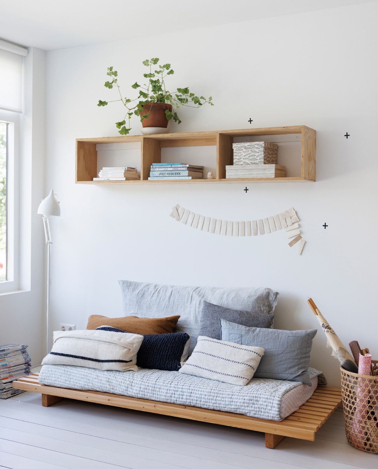 Kast aan de muur en bank zelfgemaakt. Kussens By Mölle van BijDaan. Slinger en papieren dozen Atelier Sukha. Mand Manggis Living van BijDaan. Overig onbekend. vtwonen special binnenkijken 12-2023 | fotografie Margriet Hoekstra