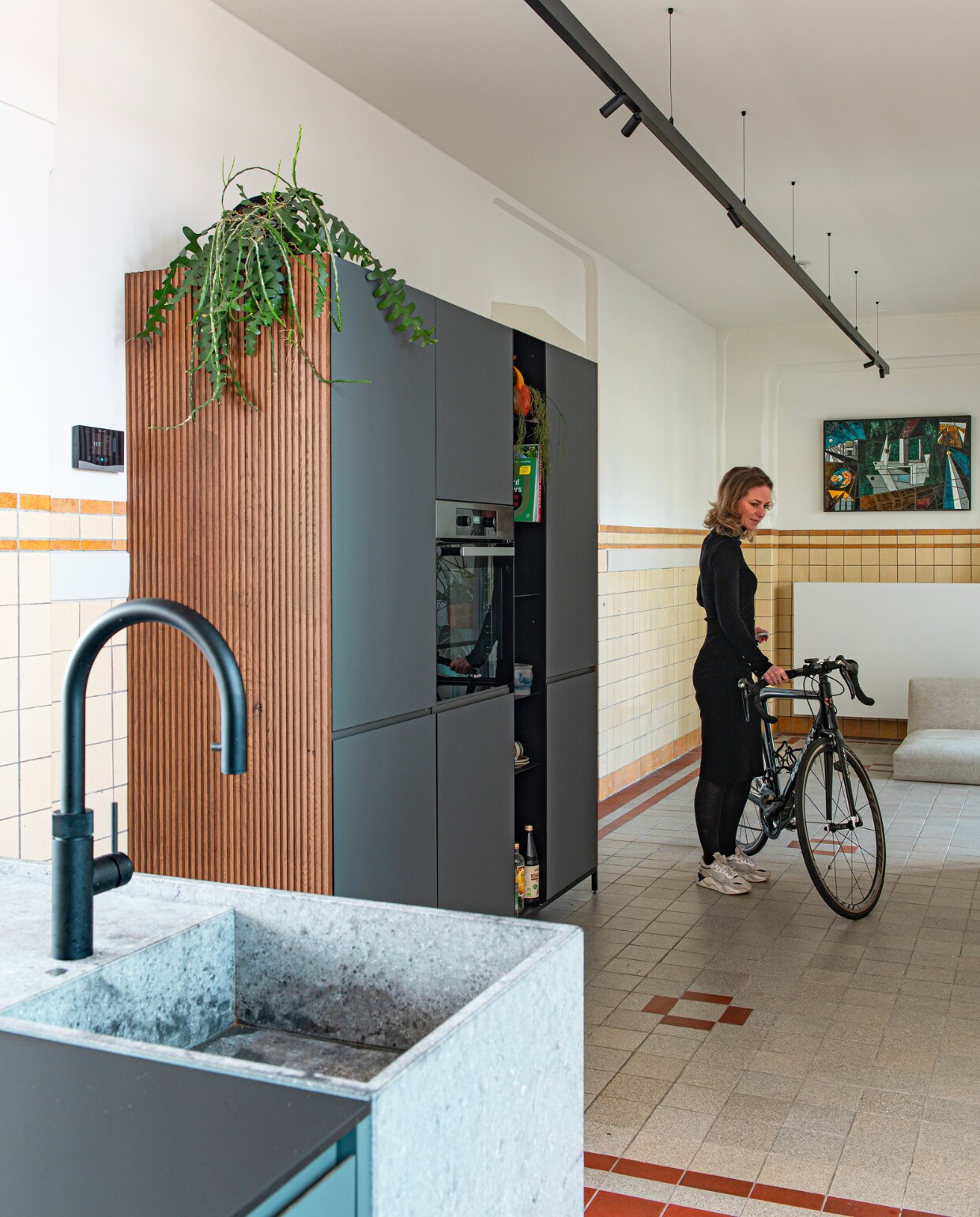 Keuken en wandkast van Houtmerk, kraan Quooker, magnetische lichtrail met smartspots 48V van Riva, tegeltableau van de Rotterdamse haven cadeau gekregen. Overig onbekend. vtwonen special binnenkijken 11-2023 | productie De Binnenkijkers | styling Jeske Weel | fotografie Caroline Coehorst