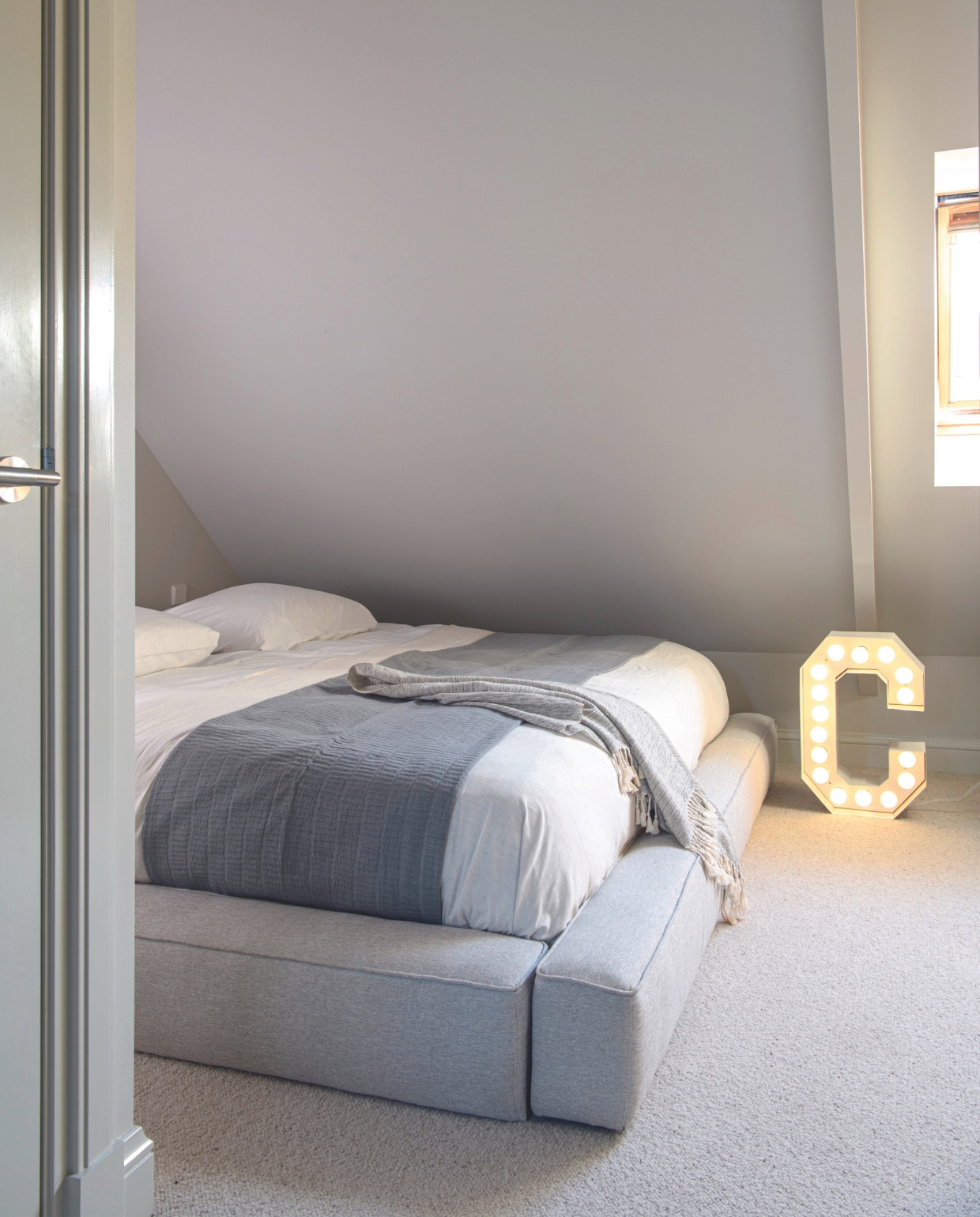Bed handgemaakt in Mexico, antraciete plaid Mint &amp; Lime, lichtgrijze plaid uit textielmuseum in Mexico, letterlamp Vegaz van Seletti, tapijt 108 Auckland in beige 027 van Hamat. Overig onbekend. vtwonen 03-2024 | productie Insidehomepage | styling Esther Loonstijn | fotografie Louis Lemaire