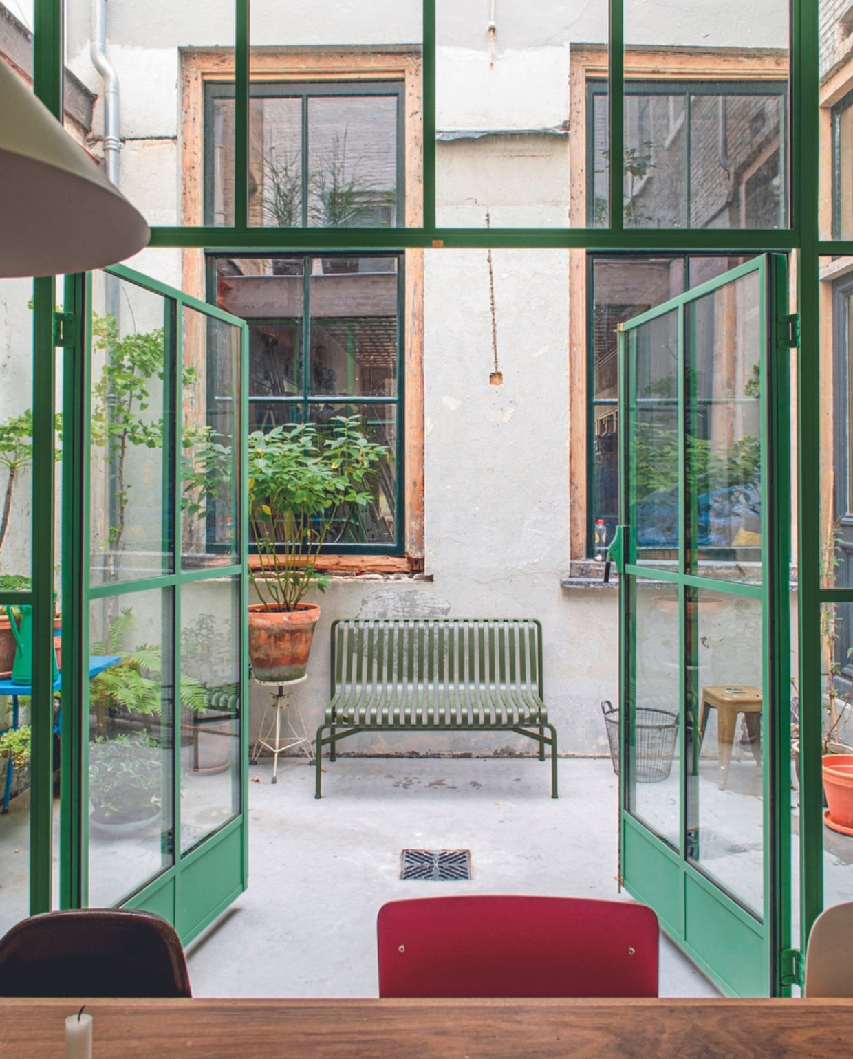 Bank op patio Hay, stalen pui Metalworks. Overig kringloopwinkel of onbekend. vtwonen 04-2024 | productie De Binnenkijkers | styling Jeske Weel | fotografie Caroline Coehorst