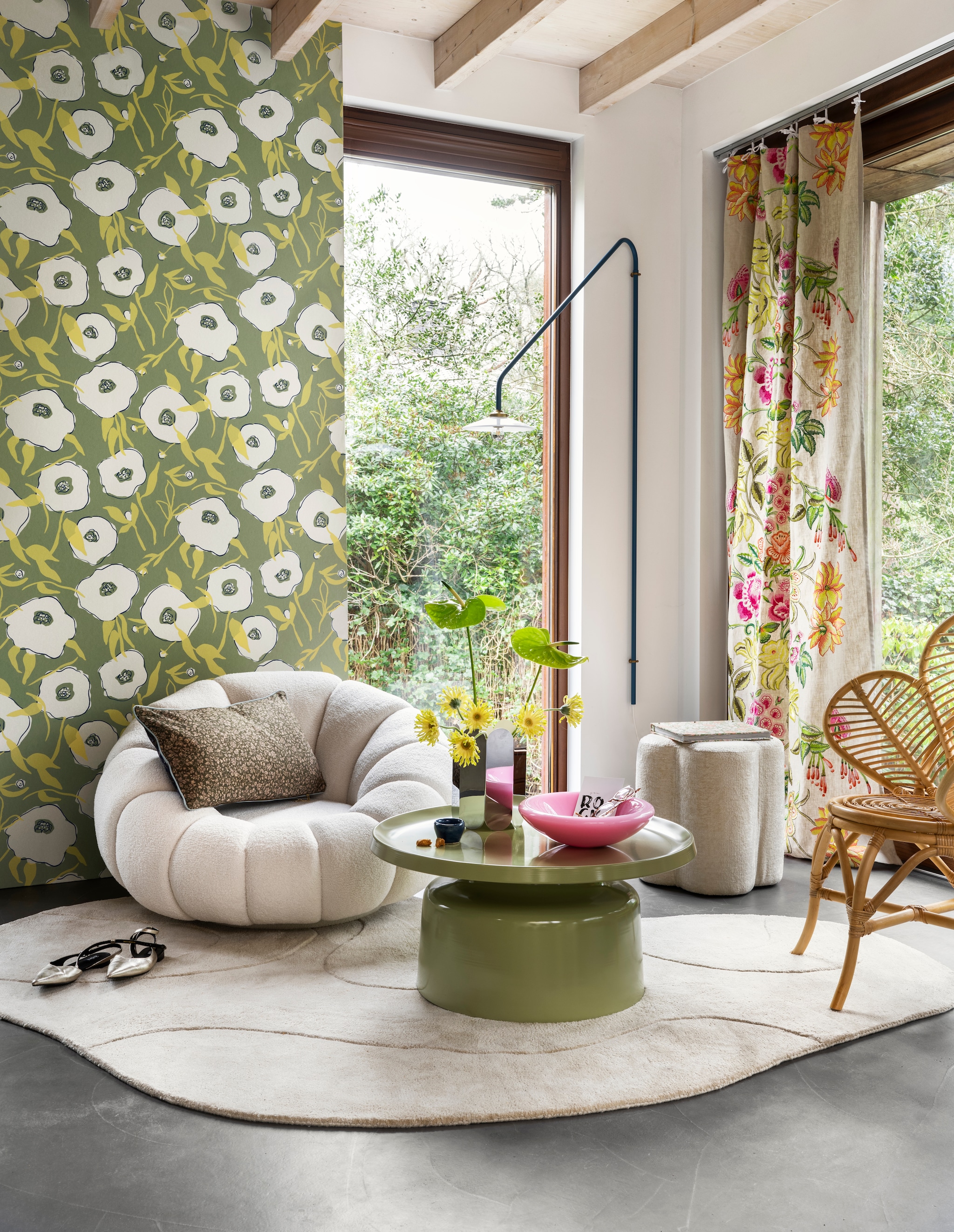Vliesbehang Goja Bunta in Sage, 10,05x0,53 cm (lxb), per rol € 89,- (masureel.com). Polyester vloerkleed Alya van Woood Exclusive, 170x240 cm € 359,-, polyester kussen Doris for HKliving in Blue, 35x60 cm € 37,99 (vtwonen.nl/shop). Metalen salontafel Duuk van Woood, 74x35 cm (Øxh) € 179,- (basiclabel.nl). Bouclé fauteuil Georgia, 100x95x70 cm (bxdxh) € 499,-, polyester poef Flower M van Coco Maison, 40x45 cm (Øxh) € 149,-, rotan stoel Leaf, 90x40x94 cm (bxdxh) € 199,- (gigameubel.nl). Gordijn Isabella Fuchsia van Designers Guild, viscose borduurdraad op linnen € 290,- (wva.nl). Metalen vaas Arcs Mirror € 279,- (hay.nl). Kopje (kringloop). Overig privébezit. vtwonen 06-2024 | styling Kelly van Gendt | fotografie Stan Koolen