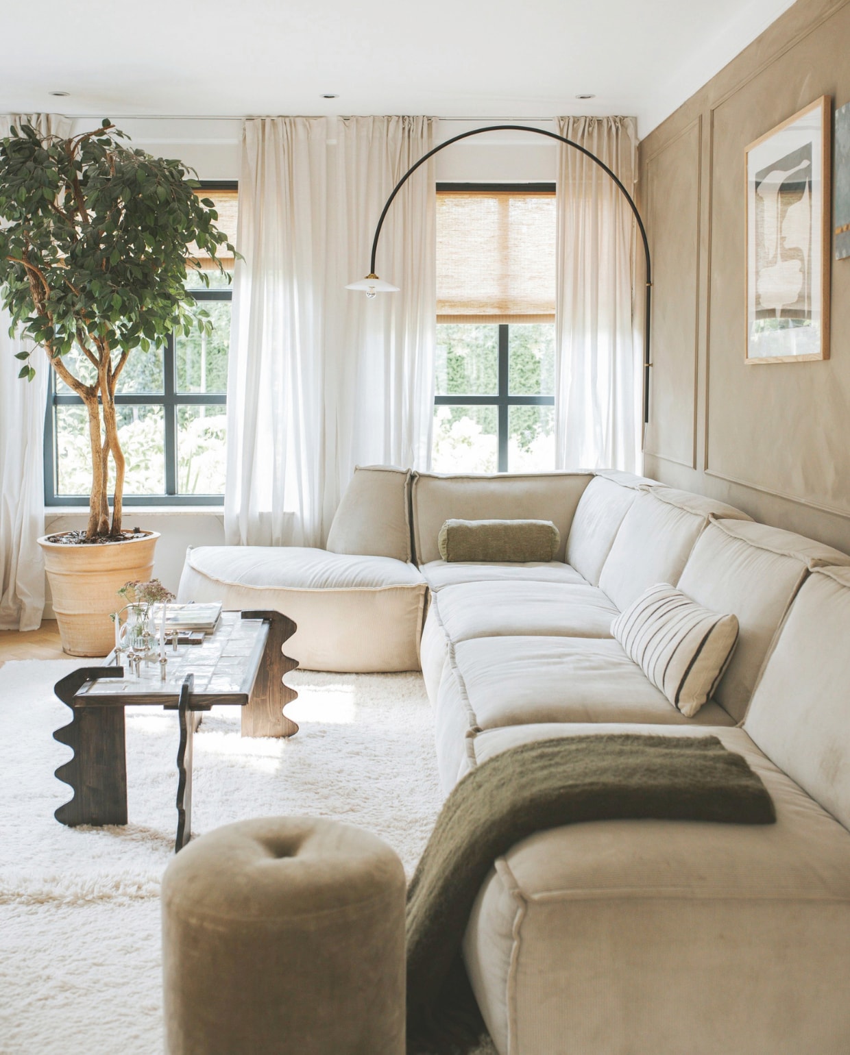 Op de muur kalkverf, zelf gemengd: Listy Fairf en RAL7006. Kleur kozijnen Railings Farrow &amp; Ball. Kunstboom en poef Marktplaats. Vloerkleed Lorena Canals. Wandlamp Valerie Objects. Jute rolgordijnen Color &amp; Co. Gordijnen Ikea. Salontafel en gestreept kussen zelfgemaakt. Bolster kussen Unique Living. Poster Pstrstore. Bank Goossens. Blauw kunstwerk erfstuk. Kandelaar Stoff Nagel. vtwonen binnenkijkspecial 11-2024 | fotografie Merel Annabel Visscher
