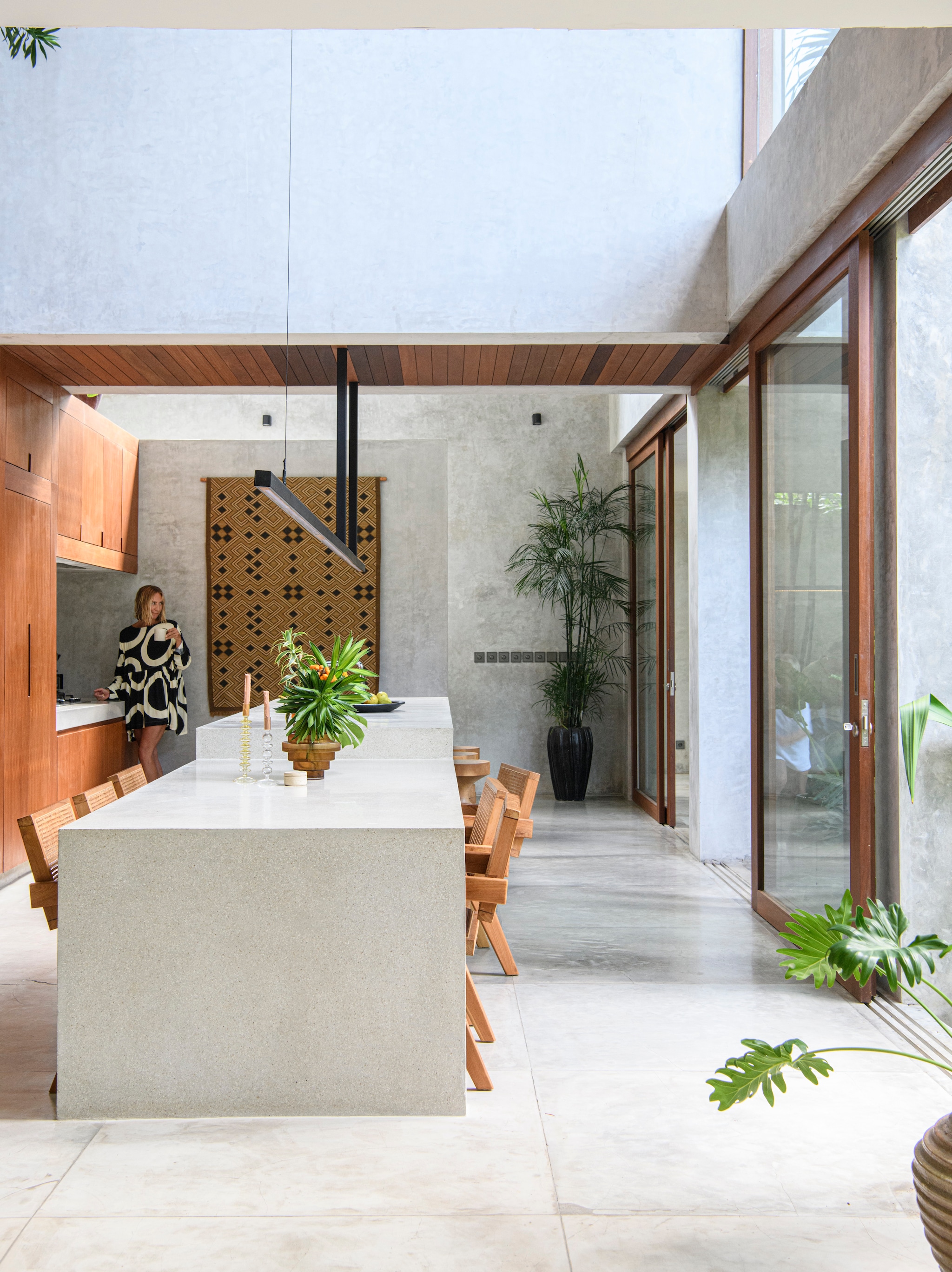 Soortgelijke wandkleden bij Deens, The Souks en The Weavery. Houten meubels op maat gemaakt door lokale ambachtslieden. Tafel en vloeren gemaakt van gepolijst beton. vtwonen 03-2024 | styling kim timmerman | fotografie louis lemaire