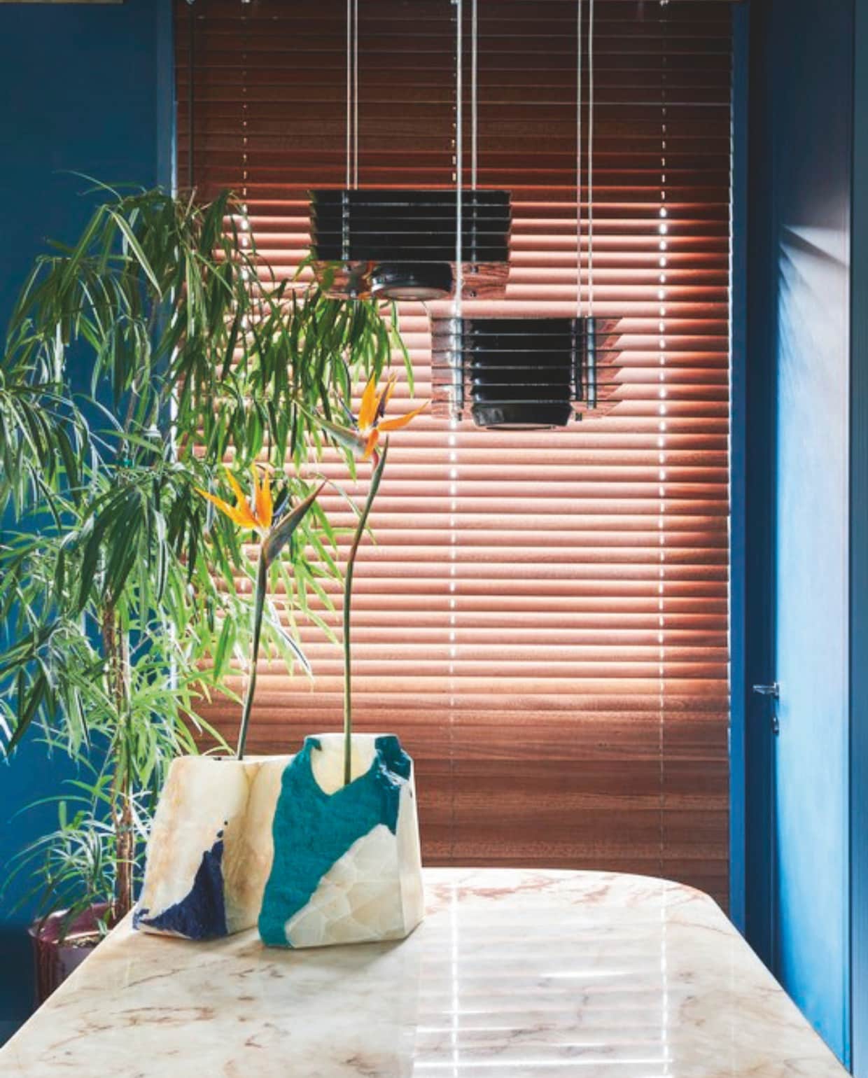 ‘Wanneer wanden, meubels en keuken dezelfde kleur hebben, werkt het goed om verschillende texturen toe te passen, zoals de latten. Dit trekt de ruimtes naar elkaar toe. Ook de jaloezieën doen mee in het lijnenspel.’ vtwonen 04-2025 | fotografie Cortili | tekst Cathelijne Jansen