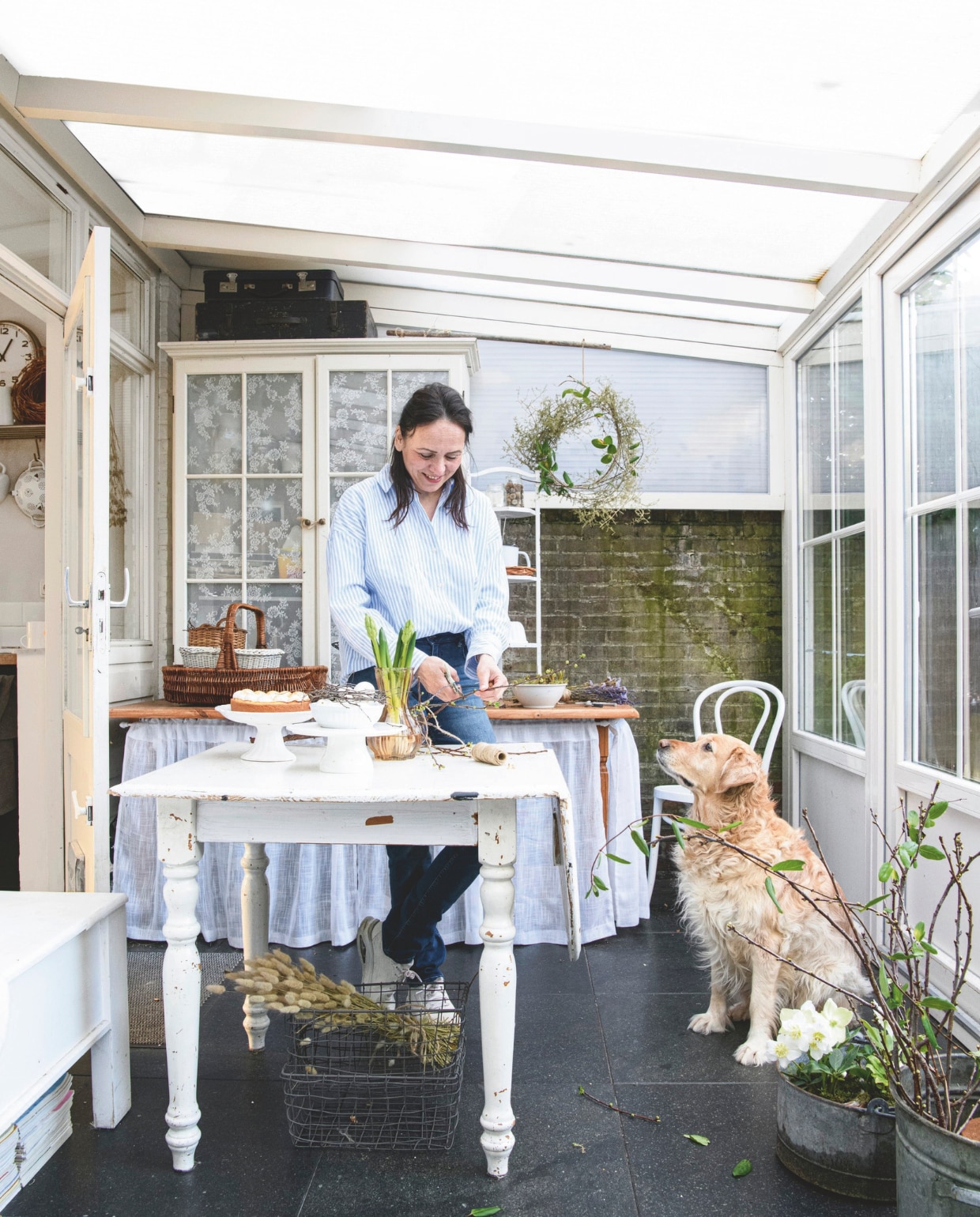 Op een mooie voorjaarsdag kunnen de ramen van de serre worden geopend. Kast meubeloutlet. Tafel tweedehands. vtwonen Landelijk 03-2025 | Styling Janneke Peters, Marit Saladini | Fotografie Louis Lemaire | Tekst Britte Kramer