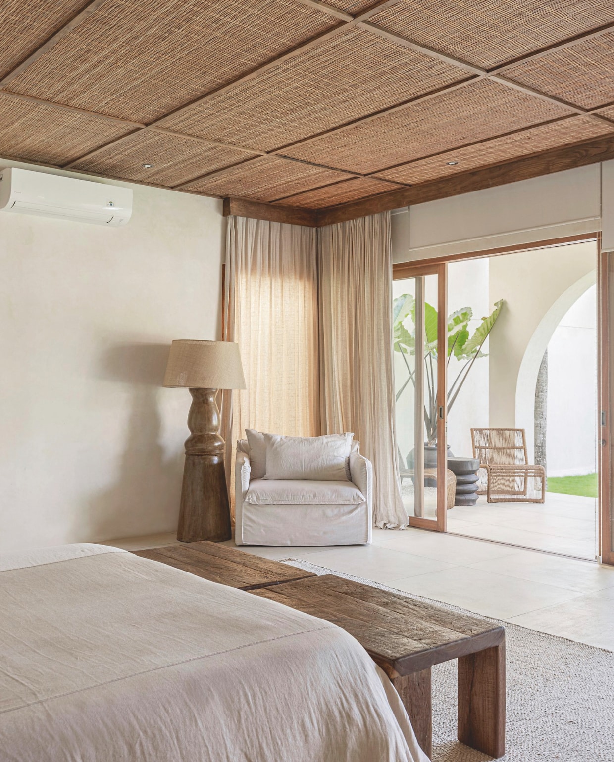 Zoe koos voor dezelfde vloer-bekleding in de slaapkamers, badkamers en de buitenruimtes, om een fijne binnen-buiten-flow te creëren. Een blikvanger is de zware vloerlamp die bestaat uit één stuk massief hout. vtwonen Landelijk 8-2025 | fotografie Sheila Man | tekstbewerking Marie Masuree