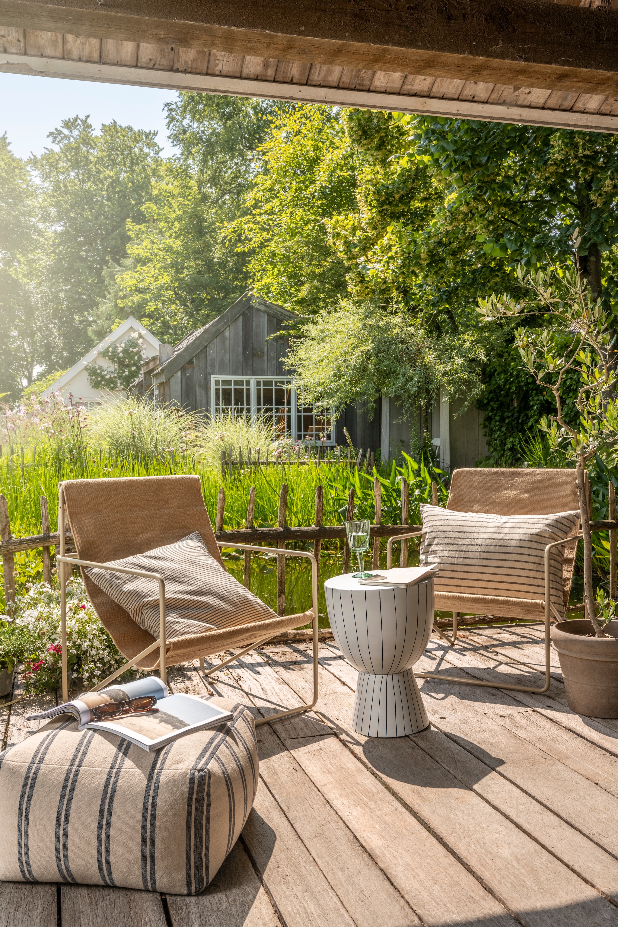 vtwonen poef, katoen en linnen, beige en grijs, 45x45x25 cm (lxbxh) € 69,95, vtwonen bijzettafel, metaal, wit en donkerblauw, 35,5x46 cm (Øxh) € 169,-, vtwonen sierkussen rechthoek, katoen en linnen, beige en donkerblauw, 70x50 cm (lxb) € 59,95, vtwonen sierkussen vierkant, katoen en linnen, beige en donkerblauw, 50x50 cm (lxb) € 44,95, vtwonen wijnglas, gerecycled glas, groen,  small, set van 4 € 49,-.M.m.v. fermliving.com (fauteuil). Overig privébezit.